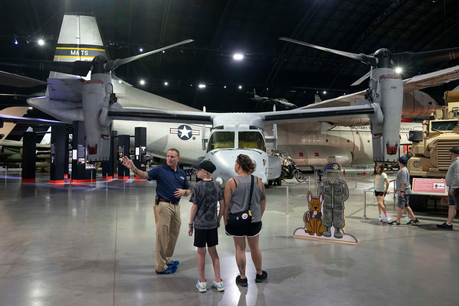 Former Air Force Osprey pilot Brian Luce, left, speaks with museum visitors inside of the Wright Patterson AFB Air Force Museum, Aug. 9, 2024, in Dayton, Ohio. (AP Photo/Jeff Dean)