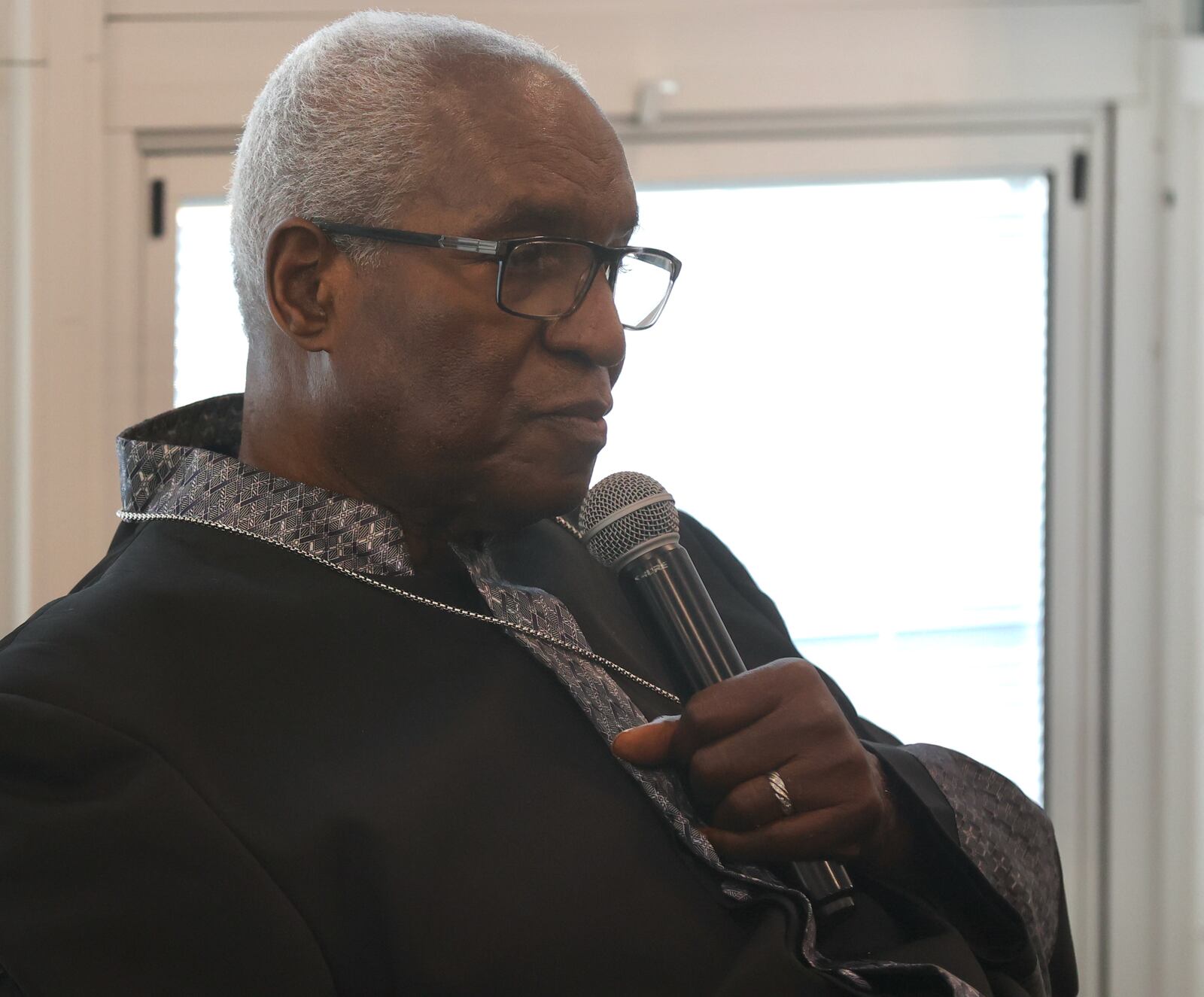 Michael Cooper Sr., of Springfield, speaks at a service held in his honor on Sunday, May 21, at Trinity Community in Fairborn. David Jablonski/Staff