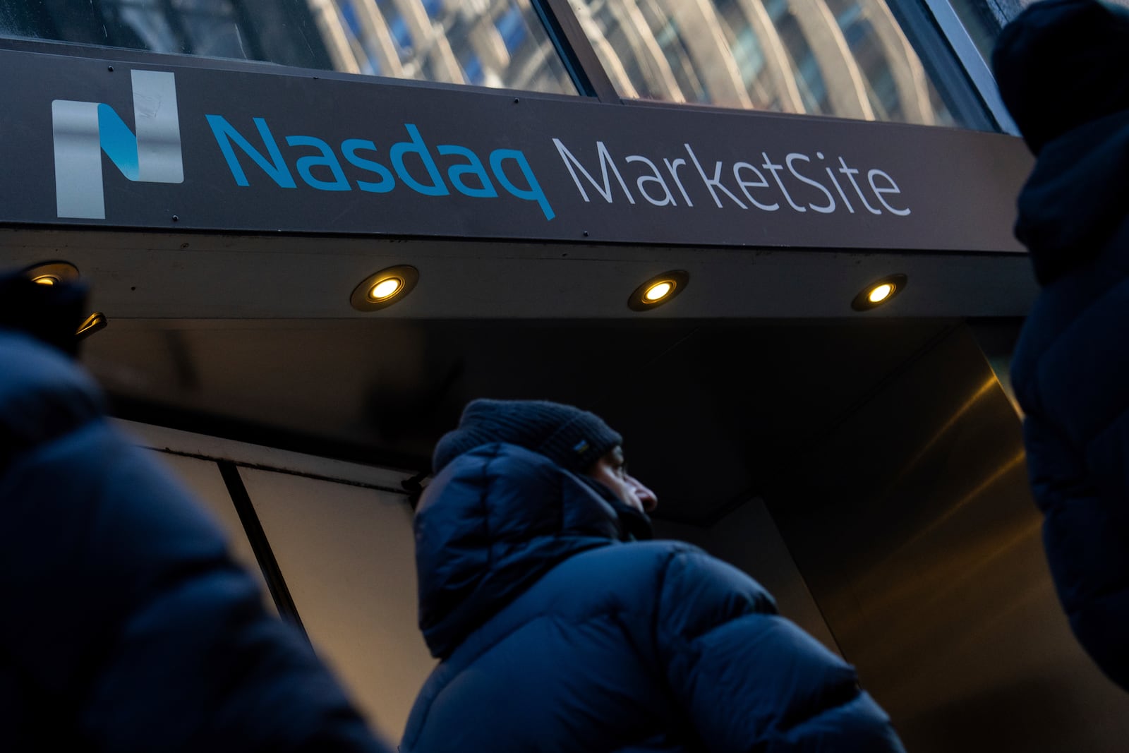 FILE - People walk past the Nasdaq MarketSite, Monday, Jan. 27, 2025, in New York. (AP Photo/Julia Demaree Nikhinson, File)