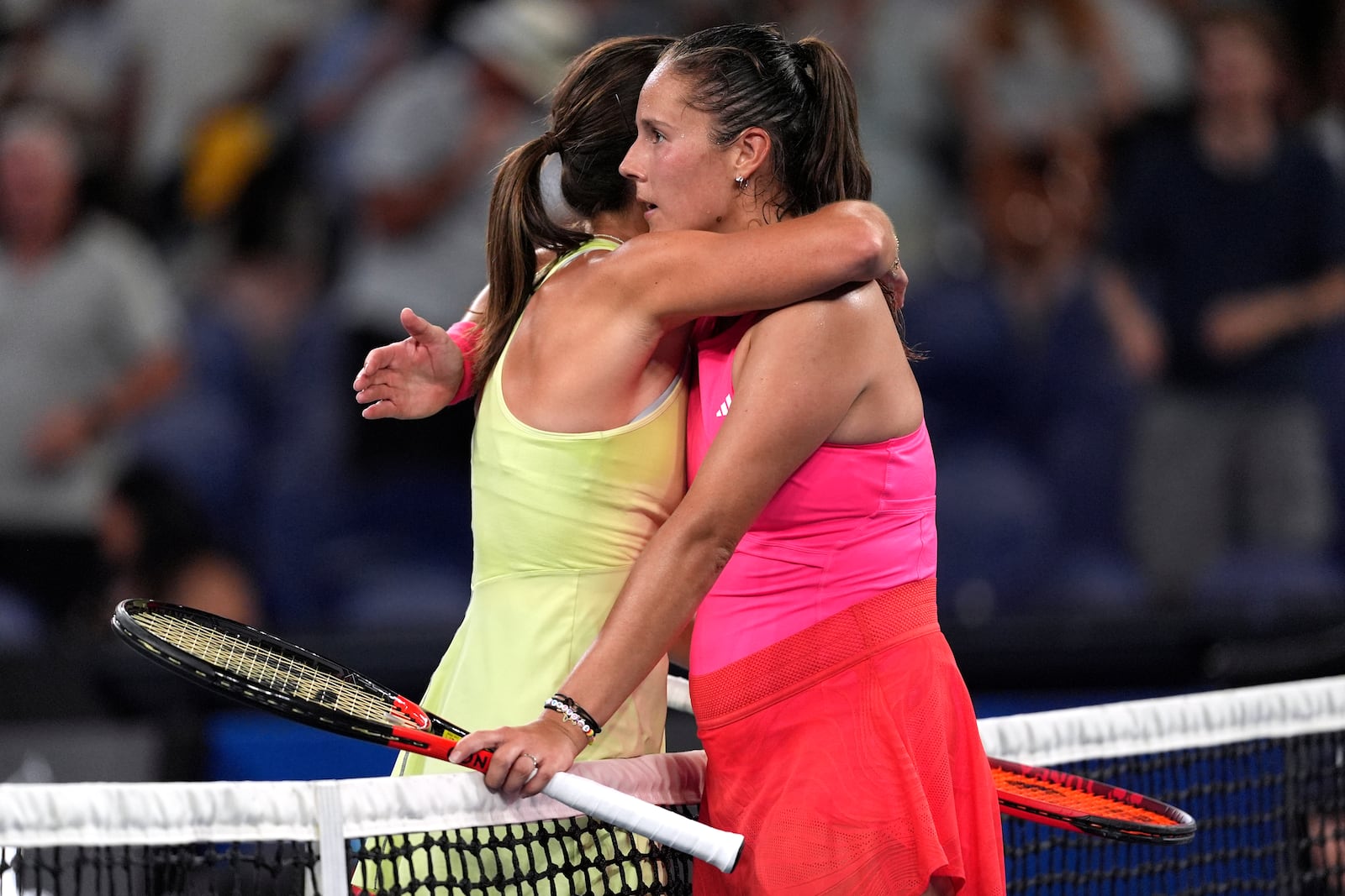 Emma Navarro, left, of the U.S. is congratulated by Daria Kasatkina of Russia following their fourth round match at the Australian Open tennis championship in Melbourne, Australia, Monday, Jan. 20, 2025. (AP Photo/Ng Han Guan)