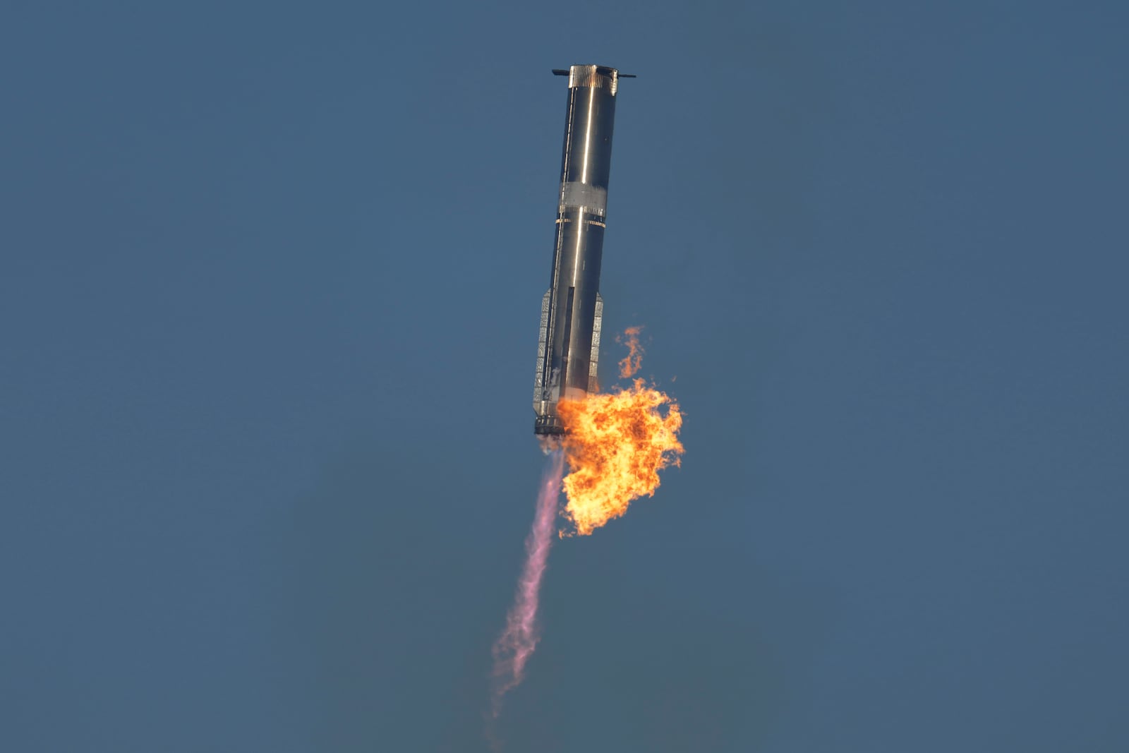 SpaceX's mega rocket Starship booster returns to the launch pad during a test flight from Starbase in Boca Chica, Texas, Thursday, Jan. 16, 2025. (AP Photo/Eric Gay)