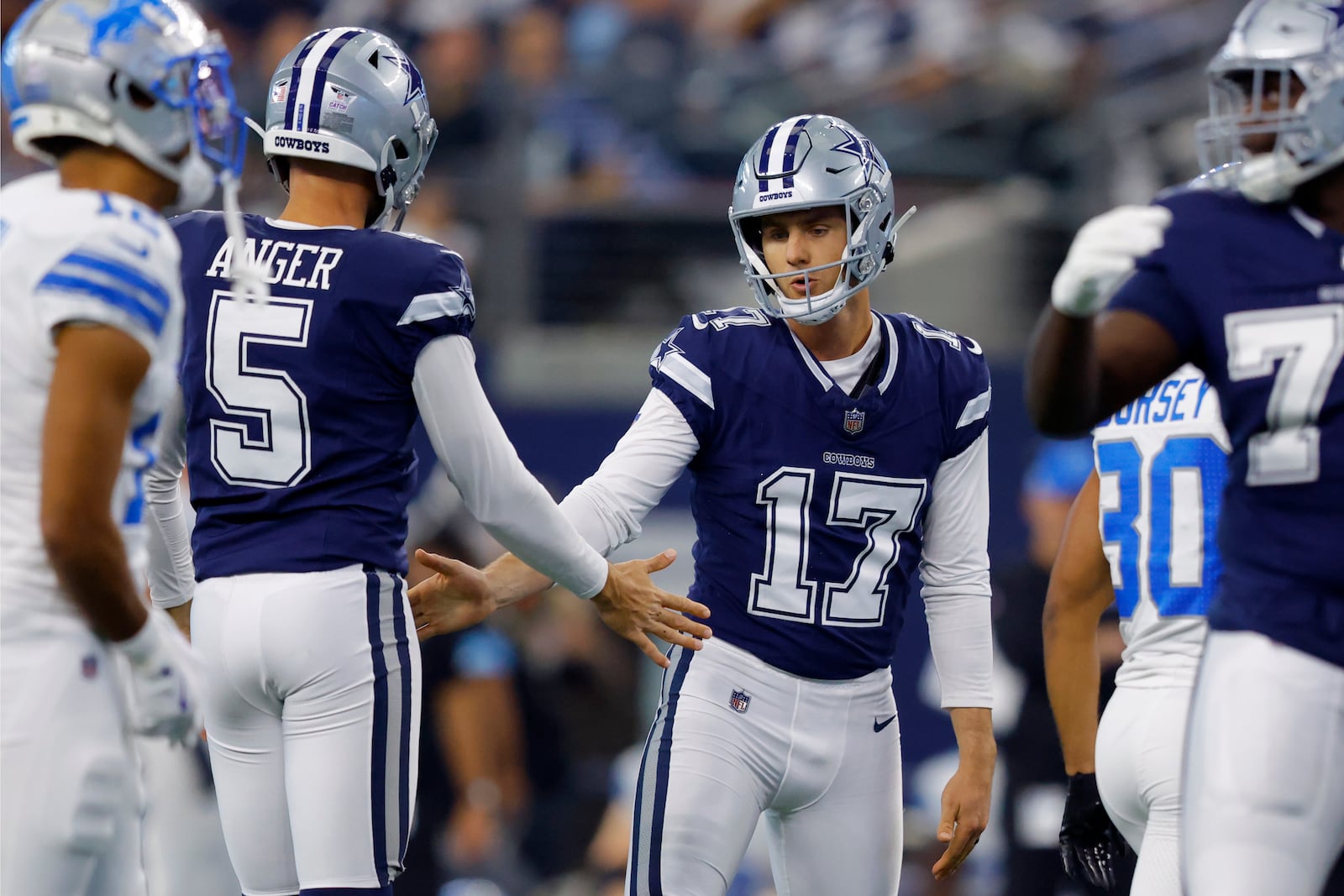 Dallas Cowboys' Bryan Anger (5) and Brandon Aubrey (17) celebrate a field goal scored by Aubrey in the first half of an NFL football game againstt he Detroit Lions in Arlington, Texas, Sunday, Oct. 13, 2024. (AP Photo/Gareth Patterson)