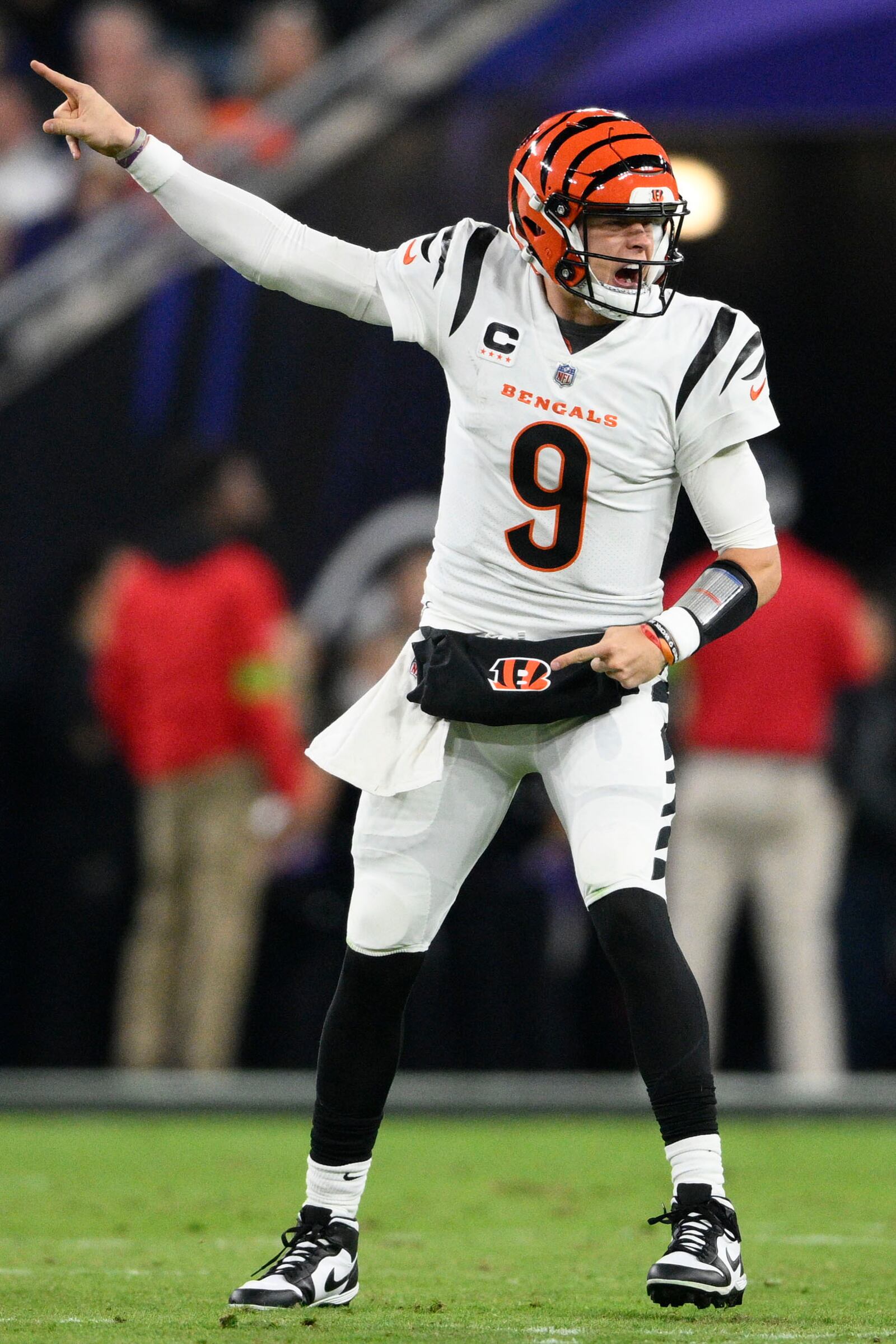 Cincinnati Bengals quarterback Joe Burrow (9) gestures at the line of scrimmage in the first half of an NFL football game against the Baltimore Ravens in Baltimore, Thursday, Nov. 16, 2023. (AP Photo/Nick Wass)