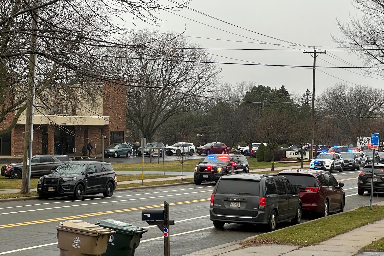 Emergency vehicles are parked outside the Abundant Life Christian School in Madison, Wis., where multiple injuries were reported following a shooting, Monday, Dec. 16, 2024. (AP Photo/Kathleen Foody)