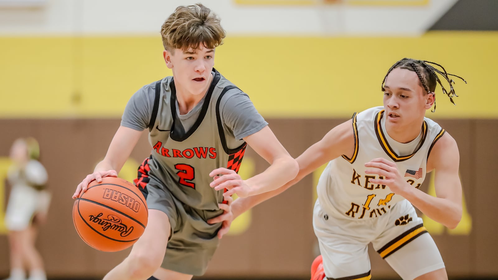 Tecumseh High School sophomore Chase Stafford drives past Kenton Ridge sophomore Xavier White during their game on Friday night in Springfield. Michael Cooper/CONTRIBUTED