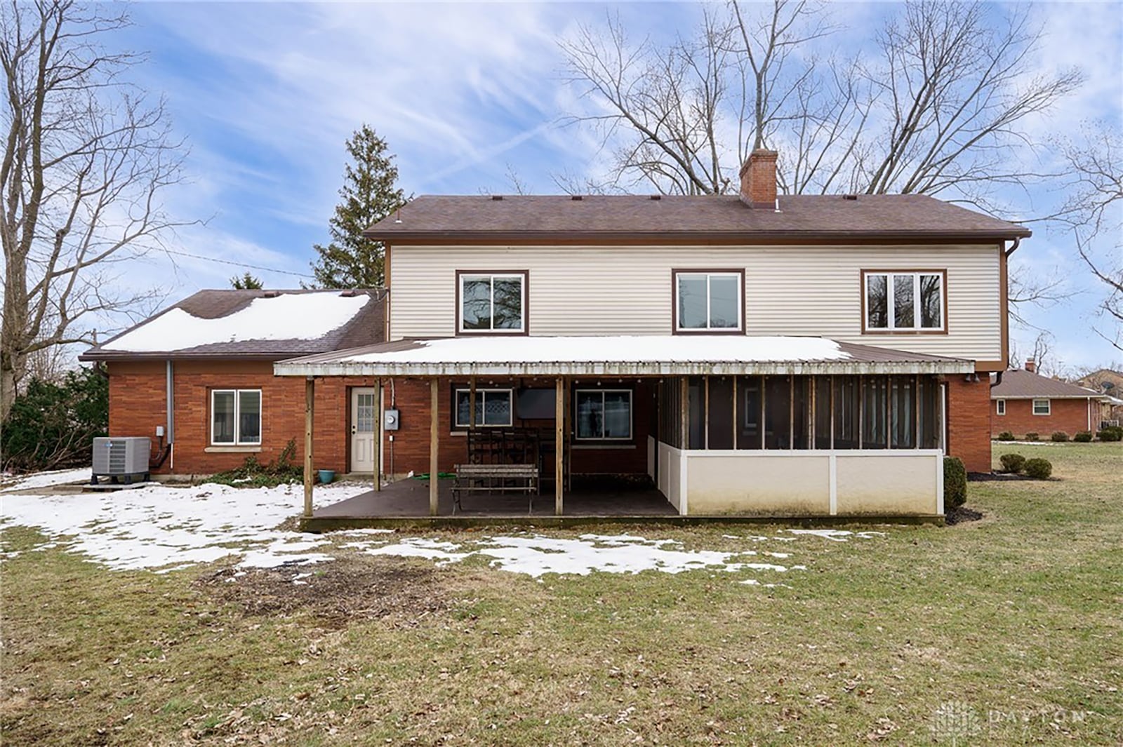 The rear of the home has a deck and sunroom and is partially fenced.