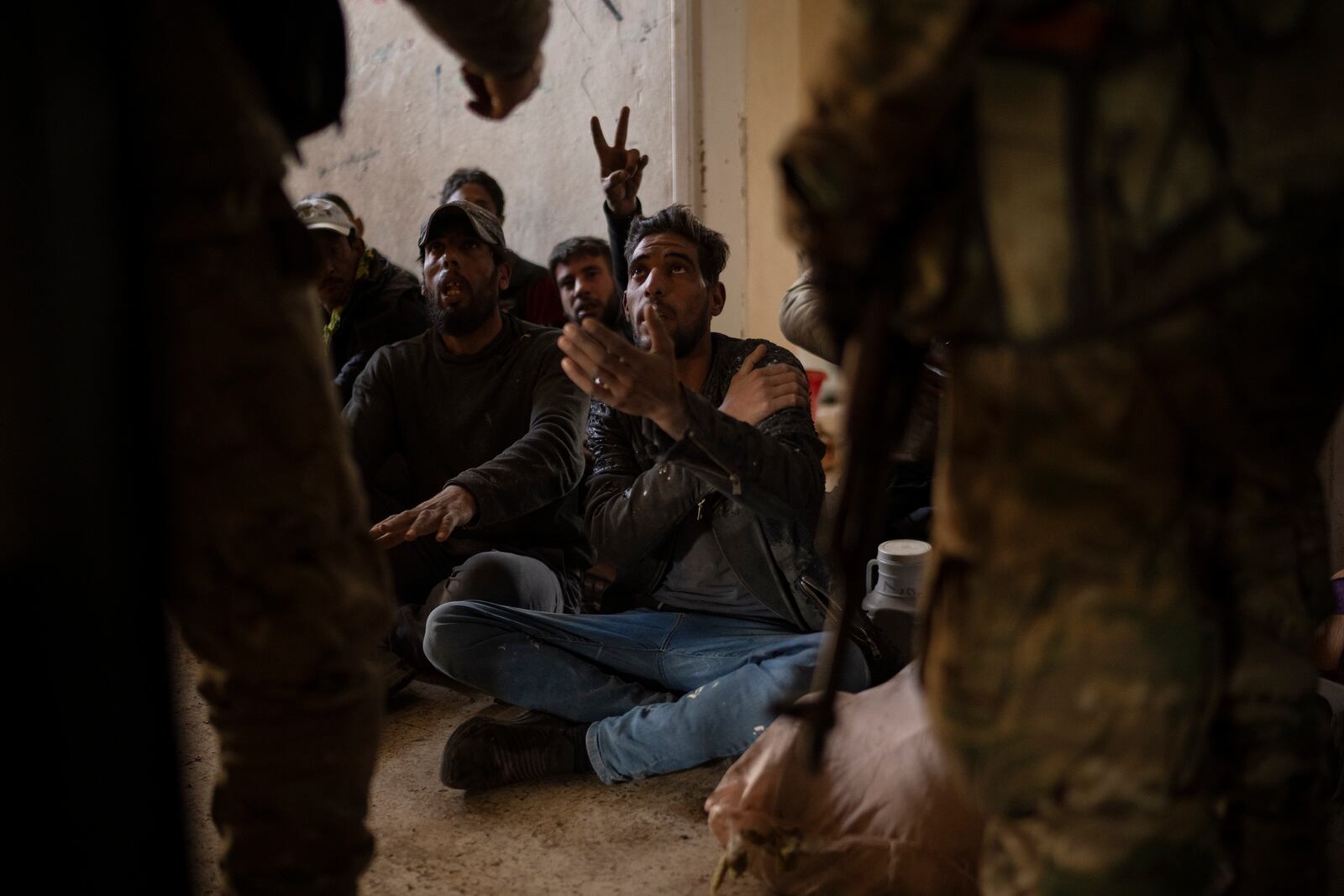 Syrian fighters detain men suspects of looting at a residential complex of former Bashar Assad's military officers at the village of Husseiniyeh, in the outskirts of Damascus, Syria, Sunday, Dec. 15, 2024. A rebel force deployed to the village in southeastern Damascus to stop looters who swarmed a residential complex in the area and set some apartments on fire. (AP Photo/Leo Correa)