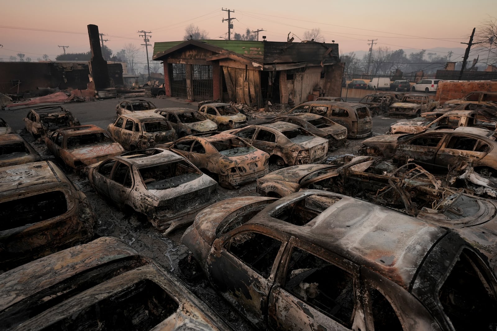 Cars are left charred inside a dealership in the aftermath of the Eaton Fire Friday, Jan. 10, 2025 in Altadena, Calif. (AP Photo/Jae C. Hong)