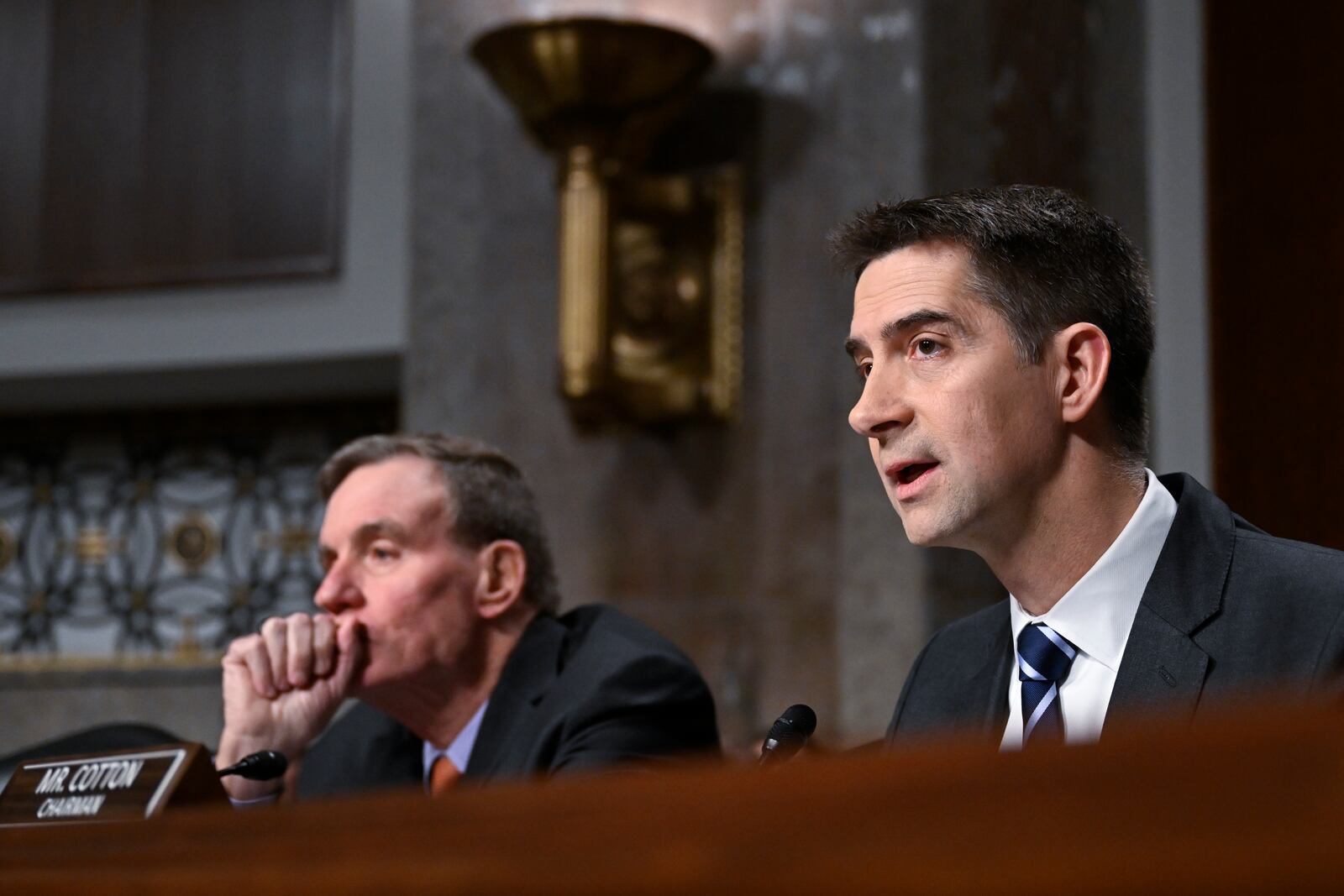 Chairman of the Senate Intelligence Committee Sen. Tom Cotton, R-Ark., right, with Vice Chairman Sen. Mark Warner, D-Va., speak with John Ratcliffe, President-elect Donald Trump's choice to be the Director of the Central Intelligence Agency, before the Senate Intelligence Committee for his confirmation hearing, at the Capitol in Washington, Wednesday, Jan. 15, 2025. (AP Photo/John McDonnell)