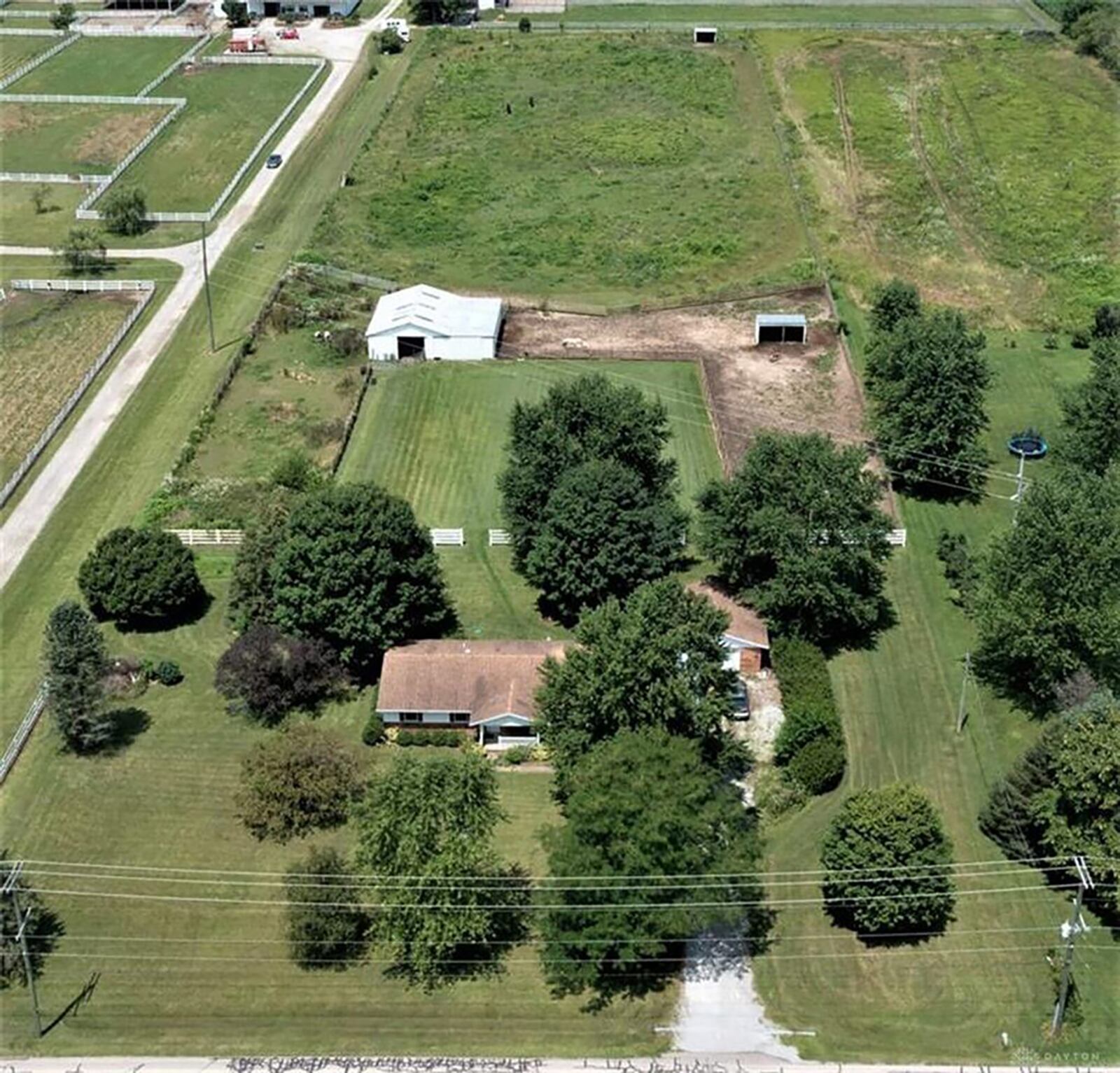 The aerial view of the home shows the property with 4-stall horse barn, run-in shelter, fully fenced horse pasture and 1-story home with detached, 2-car garage on 5 acres. CONTRIBUTED PHOTO