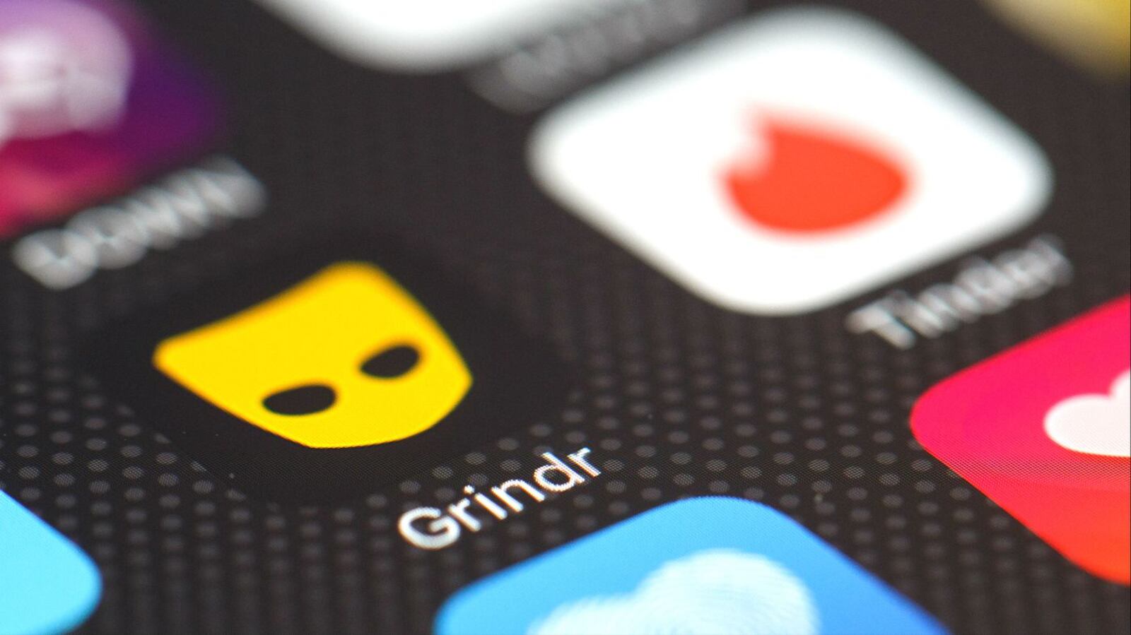 The Grindr app logo is seen among other dating apps on a cellphone screen. Mark David Latunski, 50, of Bennington Township, Mich., is charged with murder and mutilation of a body in the Dec. 24, 2019, death of a man he met on Grindr. (