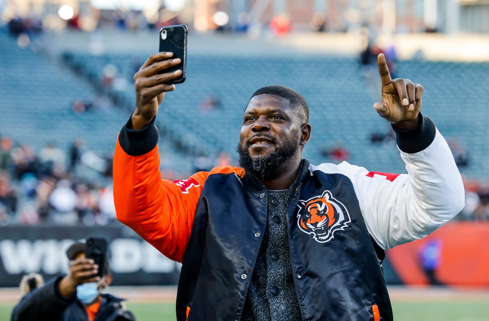 Former Cincinnati Bengal offensive lineman Willie Anderson stands on the field to cheer on the Cincinnati Bengals during the Super Bowl LVI Opening Night Fan Rally presented by Gatorade Monday, Feb. 7, 2022 at Paul Brown Stadium in Cincinnati. NICK GRAHAM/STAFF