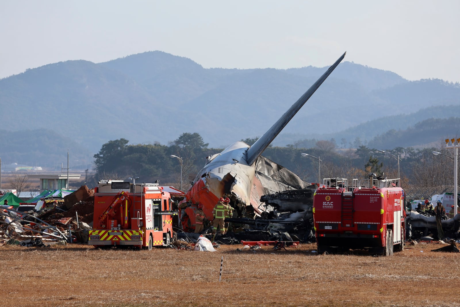 Firefighters and rescue team members work at Muan International Airport in Muan, South Korea, Sunday, Dec. 29, 2024. (Cho Nam-soo/Yonhap via AP)