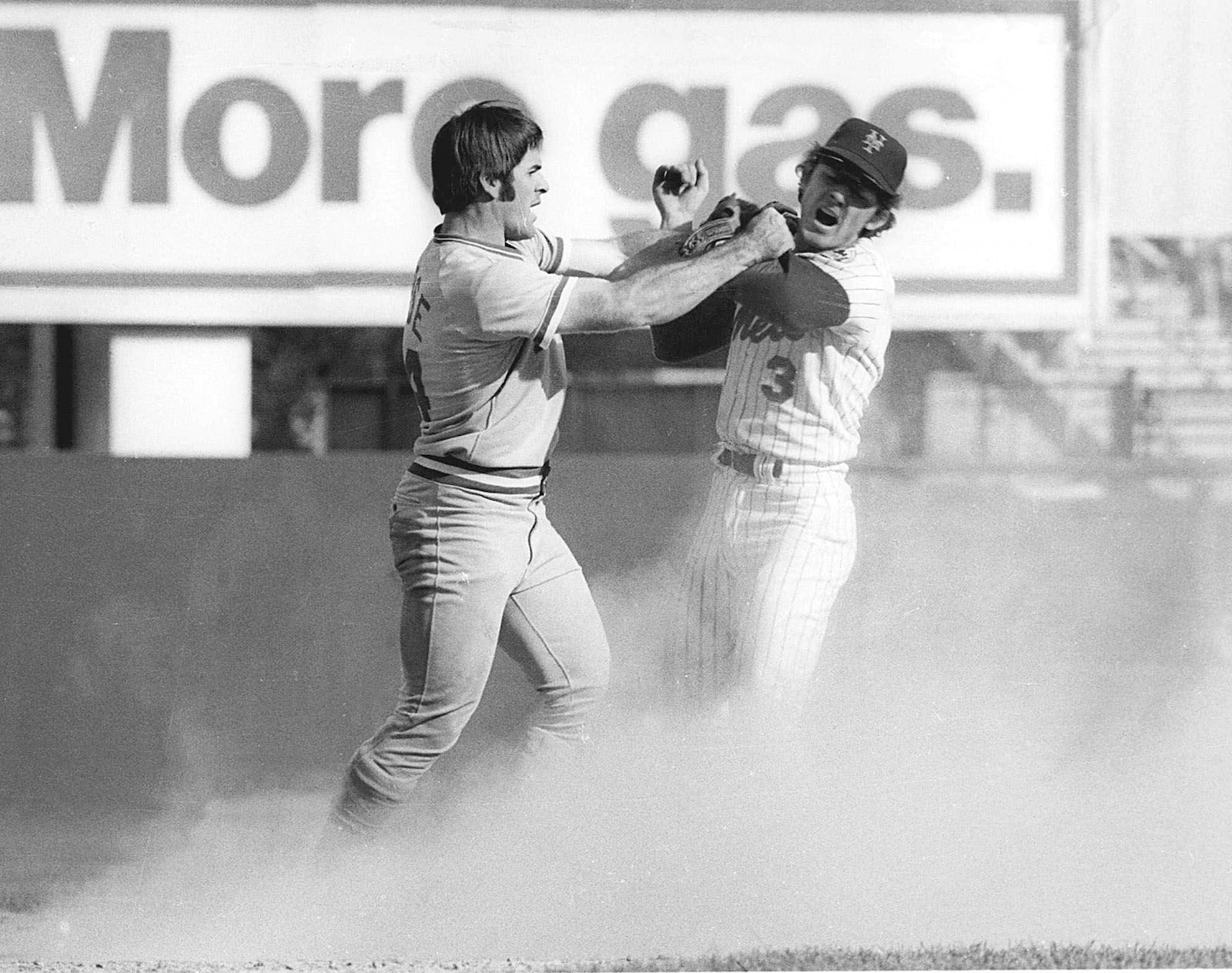 FILE - Pete Rose, left, of the Cincinnetti Reds, swings at New York Mets shortstop Bud Harrelson after Rose failed to break up Harrelson's double play in Game 3 of the National League Championship series at Shea Stadium in New York, Oct. 8, 1973. Bud Harrelson, the scrappy and sure-handed shortstop who fought Pete Rose on the field during a playoff game and helped the New York Mets win an astonishing championship, died Wednesday night, Jan. 10, 2024. He was 79. The Mets said Thursday morning that Harrelson died at a hospice house in East Northport, New York after a long battle with Alzheimer's.(AP Photo/Marty Lederhandler, File)