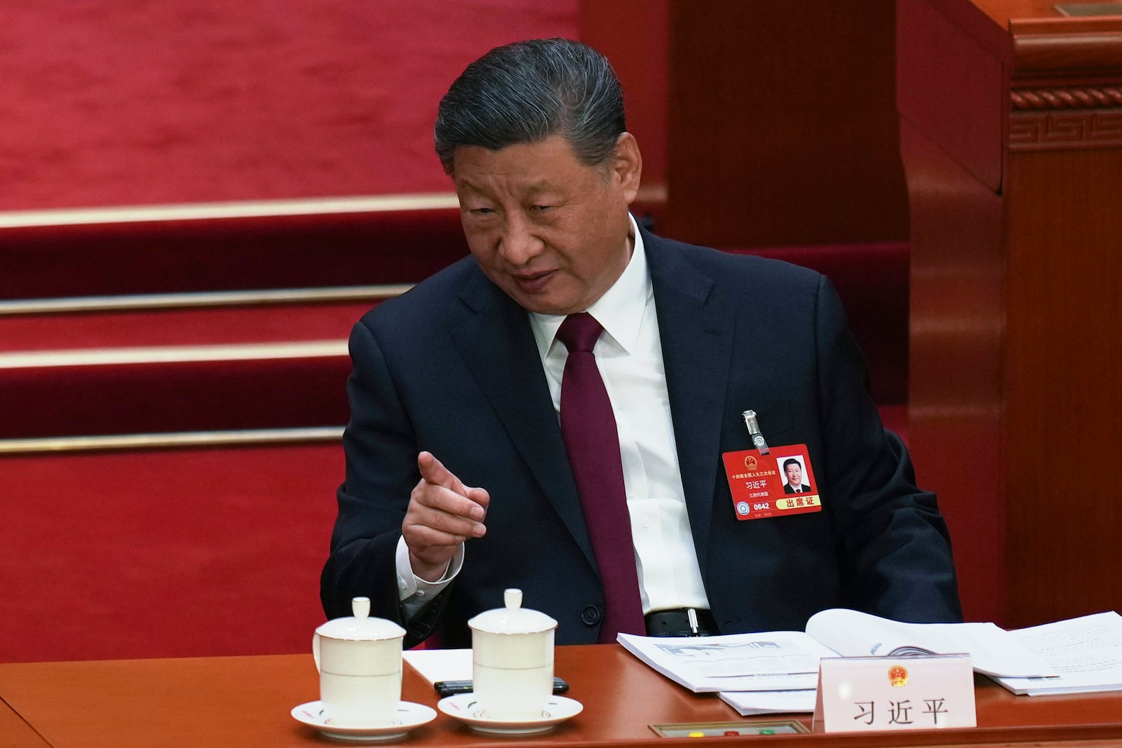 Chinese President Xi Jinping gestures during the opening session of the National People's Congress (NPC) at the Great Hall of the People in Beijing, China, Wednesday, March 5, 2025. (AP Photo/Ng Han Guan)