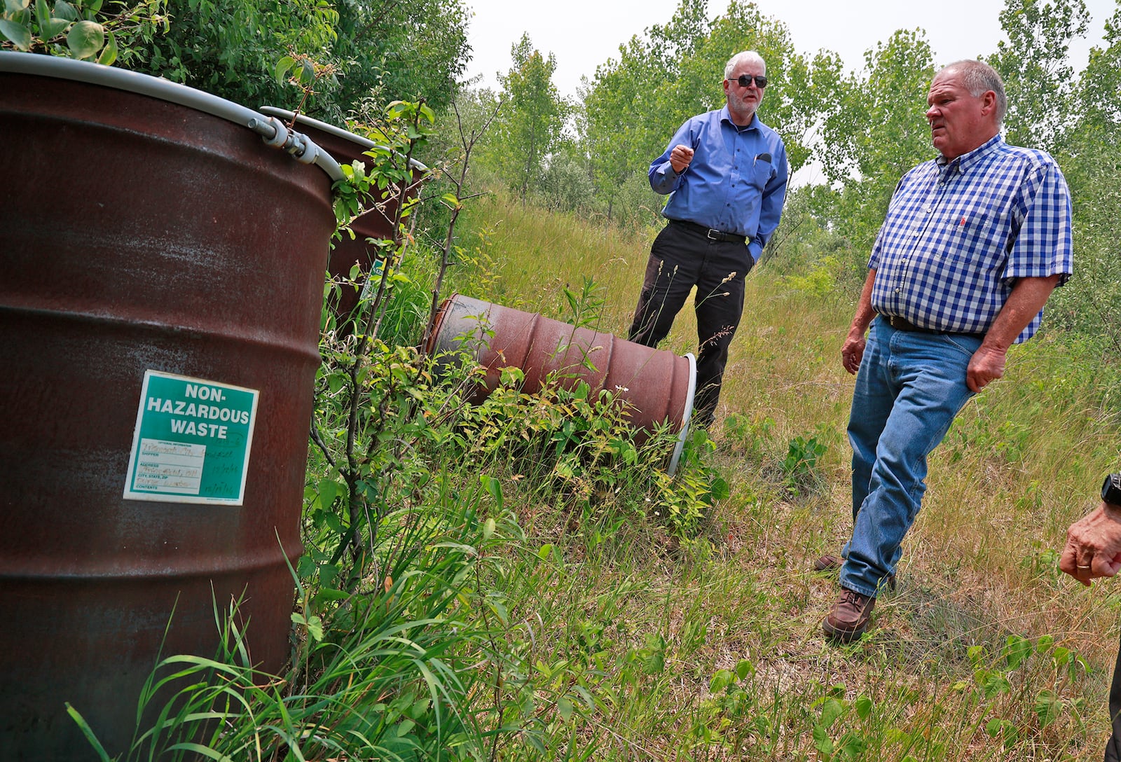 Larry Ricketts (left) of the People for Safe Water group surveys the Tremont City Barrel Fill site with German Twp. trustee Rodney Kaffenbarger in 2023. Tremont City is headed for cleanup, but the EPA is also concerned about the New Carlisle Landfill site. BILL LACKEY/STAFF