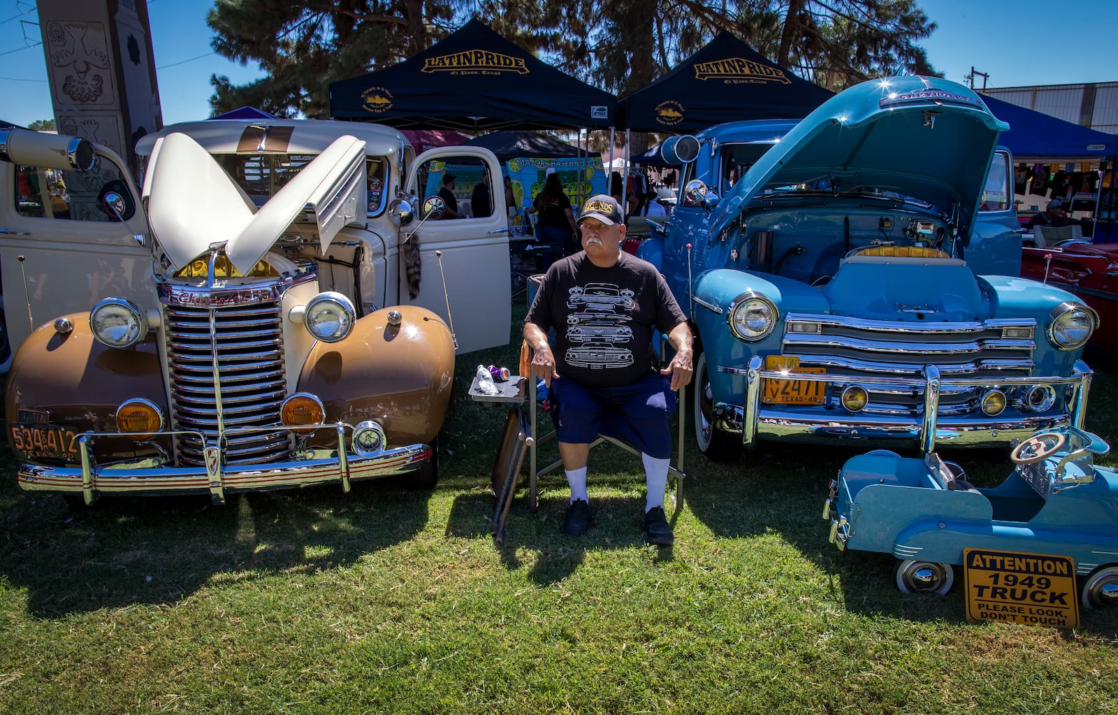 Santos Gonzalez sits between a 1939 and a 1949 Chevy vintage cars during a lowrider exhibition for the 20th anniversary of Lincoln Park in El Paso, Texas, Sunday, Sept. 22, 2024. (AP Photo/Andrés Leighton)