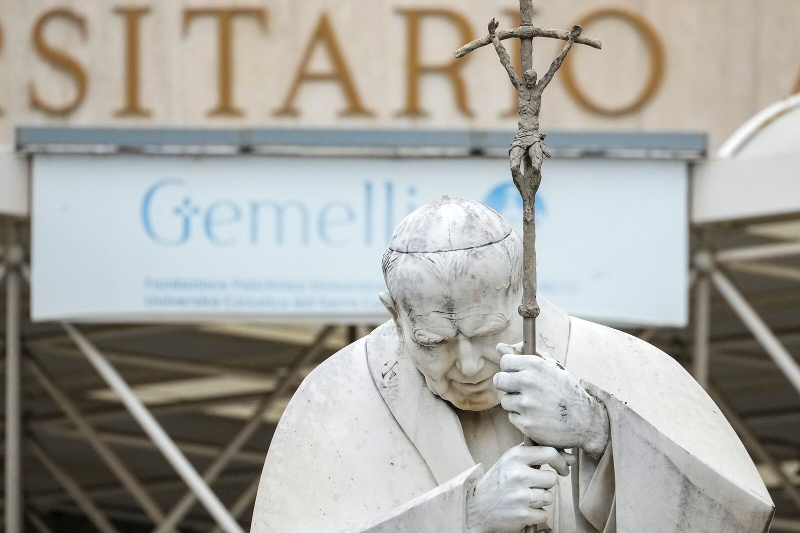 A statue of Pope John Paul II is seen in front of the Agostino Gemelli Polyclinic, in Rome, Tuesday, Feb. 18, 2025, where Pope Francis has been hospitalised to undergo some necessary diagnostic tests and to continue his ongoing treatment for bronchitis. (AP Photo/Andrew Medichini)