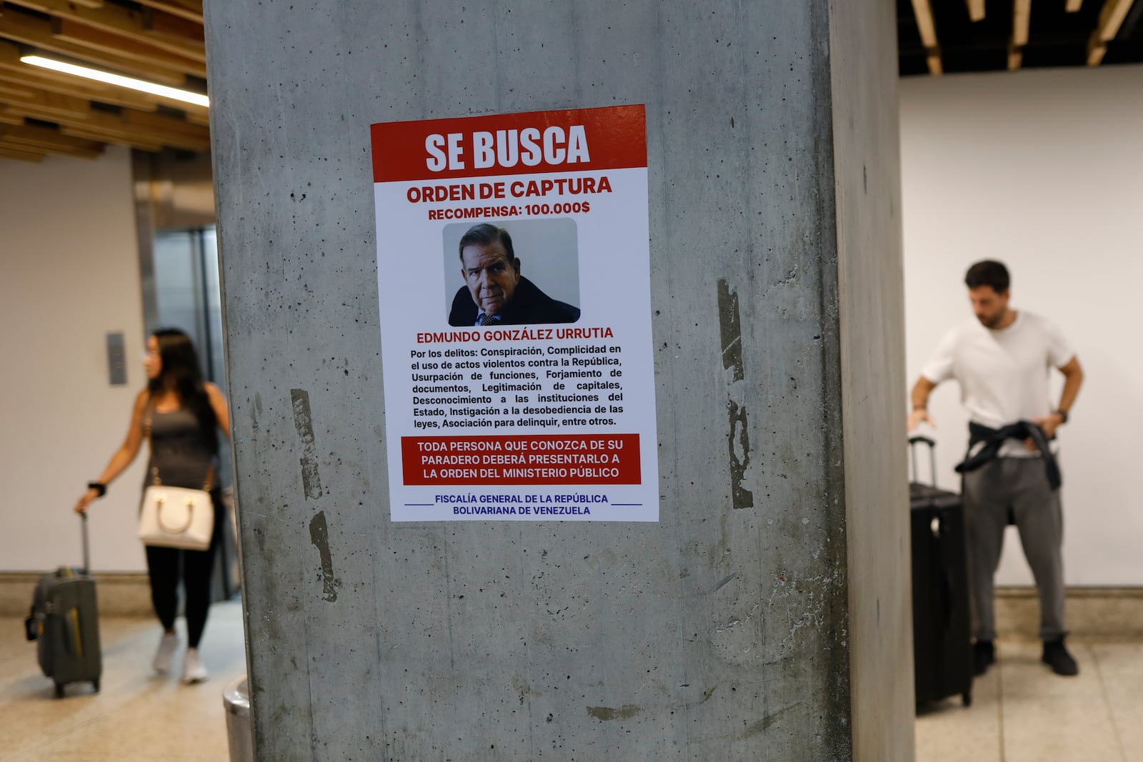 A wanted poster of Venezuela's opposition leader Edmundo Gonzalez covers a column at the Simon Bolivar International Airport in Maiquetia, near Caracas, Venezuela, Friday, Jan. 3, 2025. (AP Photo/Cristian Hernandez)