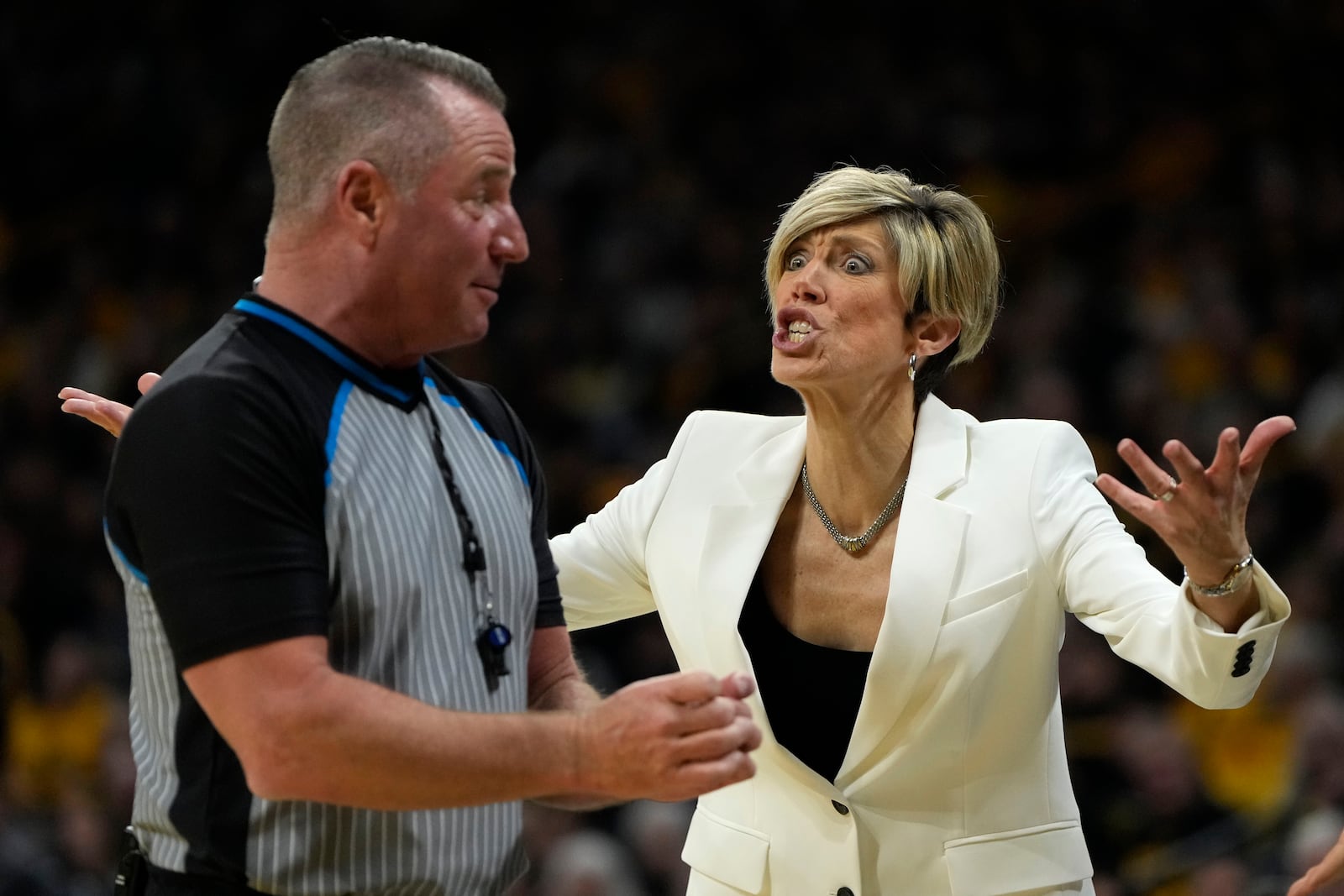 Iowa head coach Jan Jensen, right, questions a call during the first half of an NCAA college basketball game against the Southern California, Sunday, Feb. 2, 2025, in Iowa City, Iowa. (AP Photo/Charlie Neibergall)