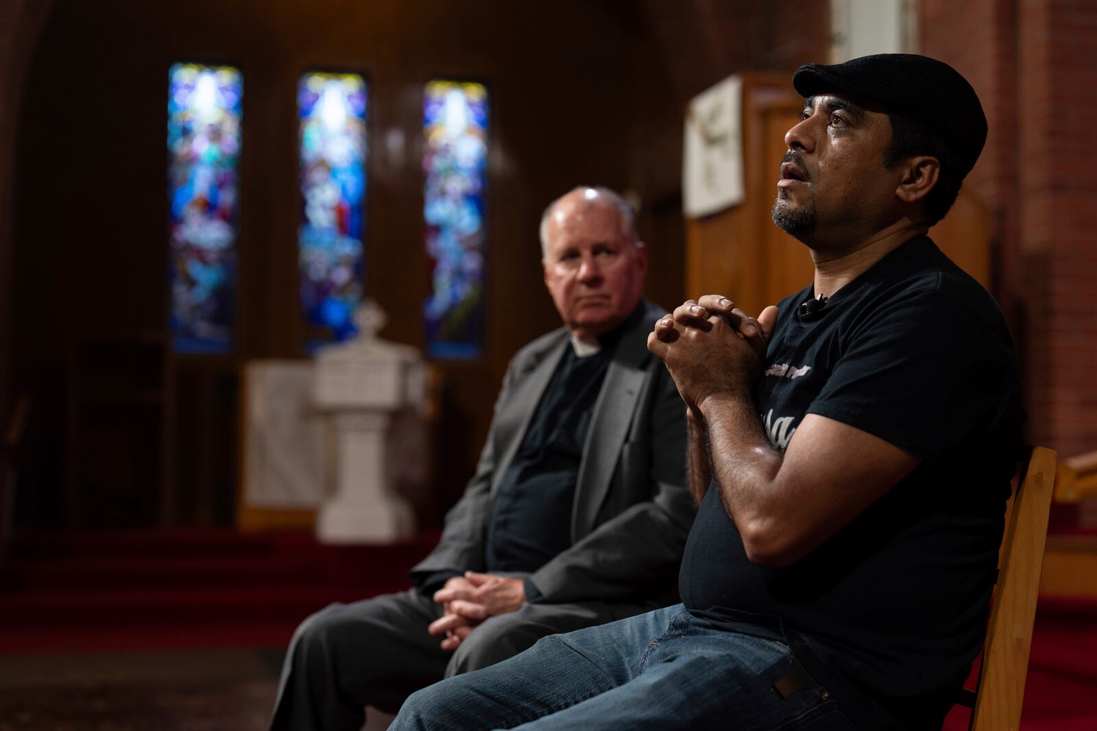 Rev. W. J. Mark Knutson, left, listens as Juan Francisco Aguirre-Velasquez gives an interview at the Augustana Lutheran Church, Thursday, Jan. 9, 2025, in Portland, Oregon. Aguirre-Velasquez, originally from El Salvador, sought sanctuary in the church to avoid deportation in 2014. (AP Photo/Jenny Kane)