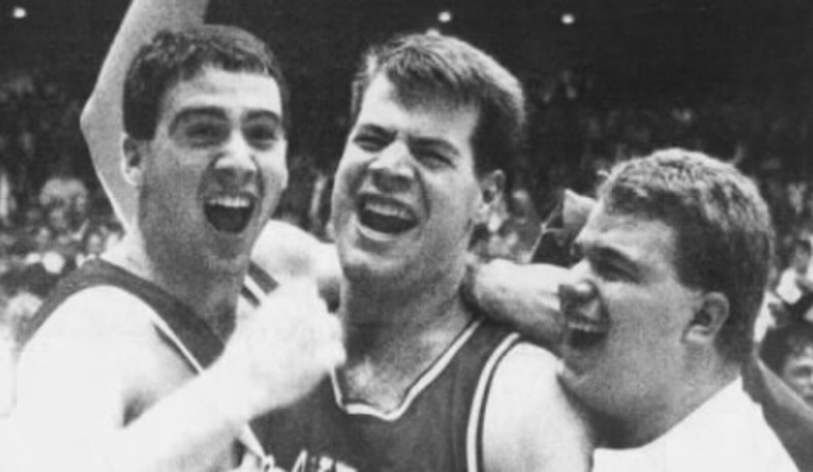 Dayton's Sam Howard, center, celebrates with two fans after a victory against Xavier in the MCC tournament final at UD Arena on March 10, 1990.