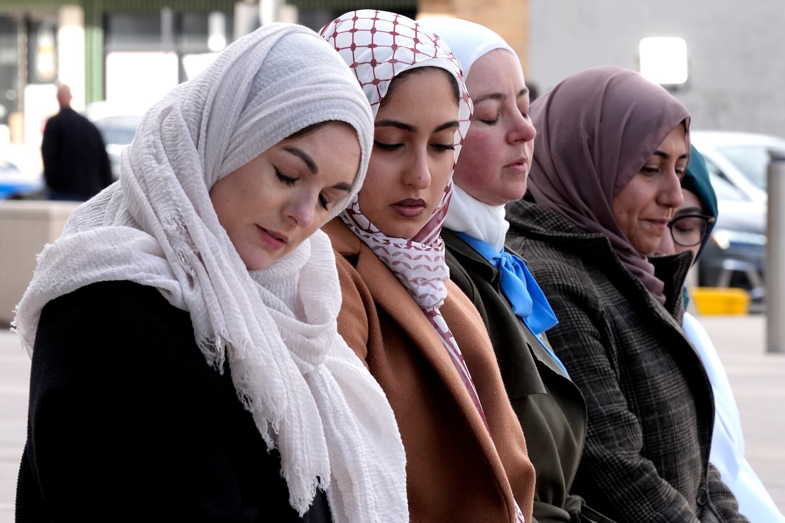 Hela Yousef, second from left, cousin of 6-year-old Palestinian boy Wadee Alfayoumi, prays with Communications Coordinator of Council on American-Islamic Relations members outside outside the Will County Courthouse where a jury found defendant Joseph Czuba found guilty of murder and hate crime charges, Friday, Feb. 28, 2025, in Joliet, Ill. (AP Photo/Nam Y. Huh)