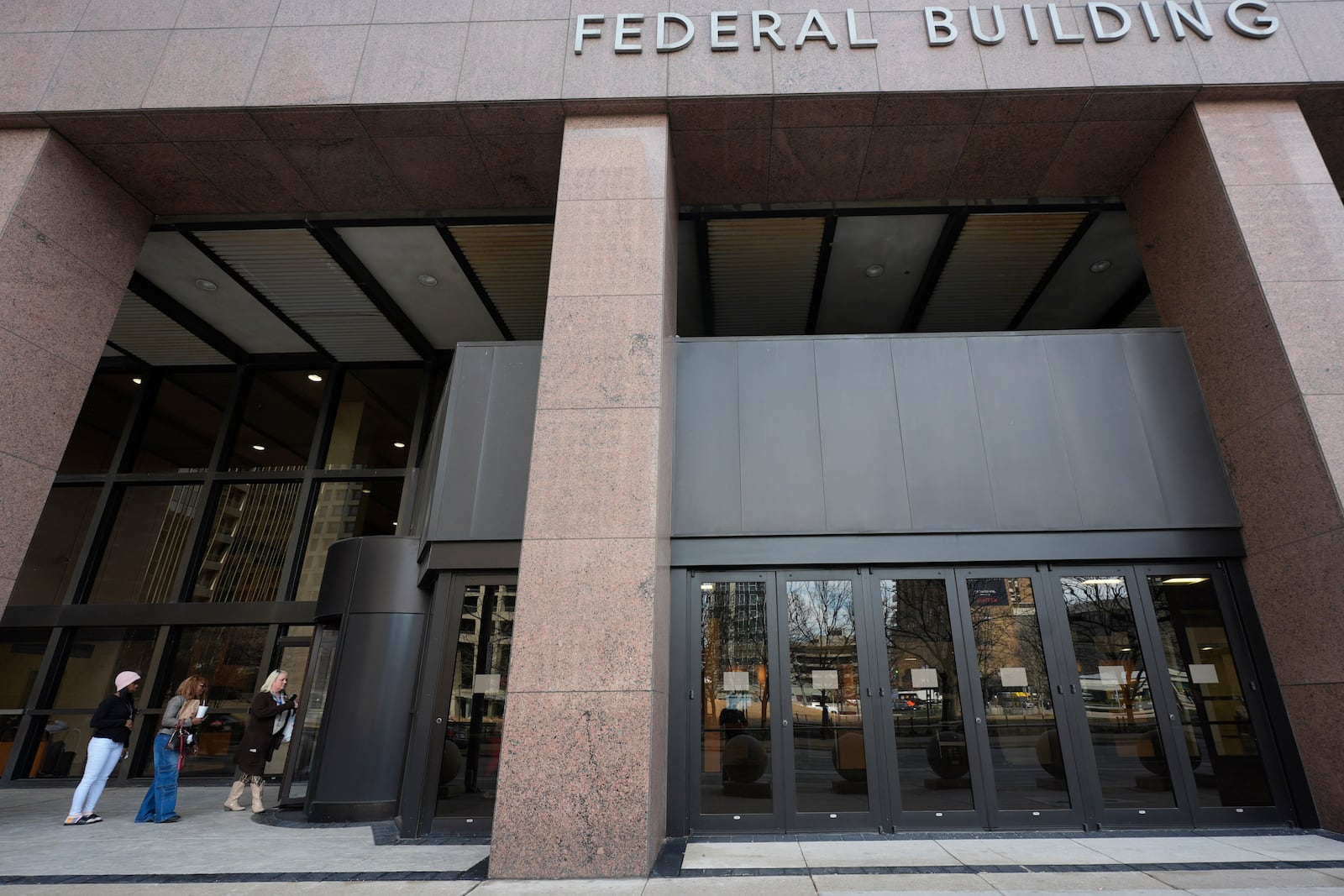 People enter the Earle Cabell Federal Building in downtown Dallas, Monday, Feb. 24, 2025. (AP Photo/LM Otero)