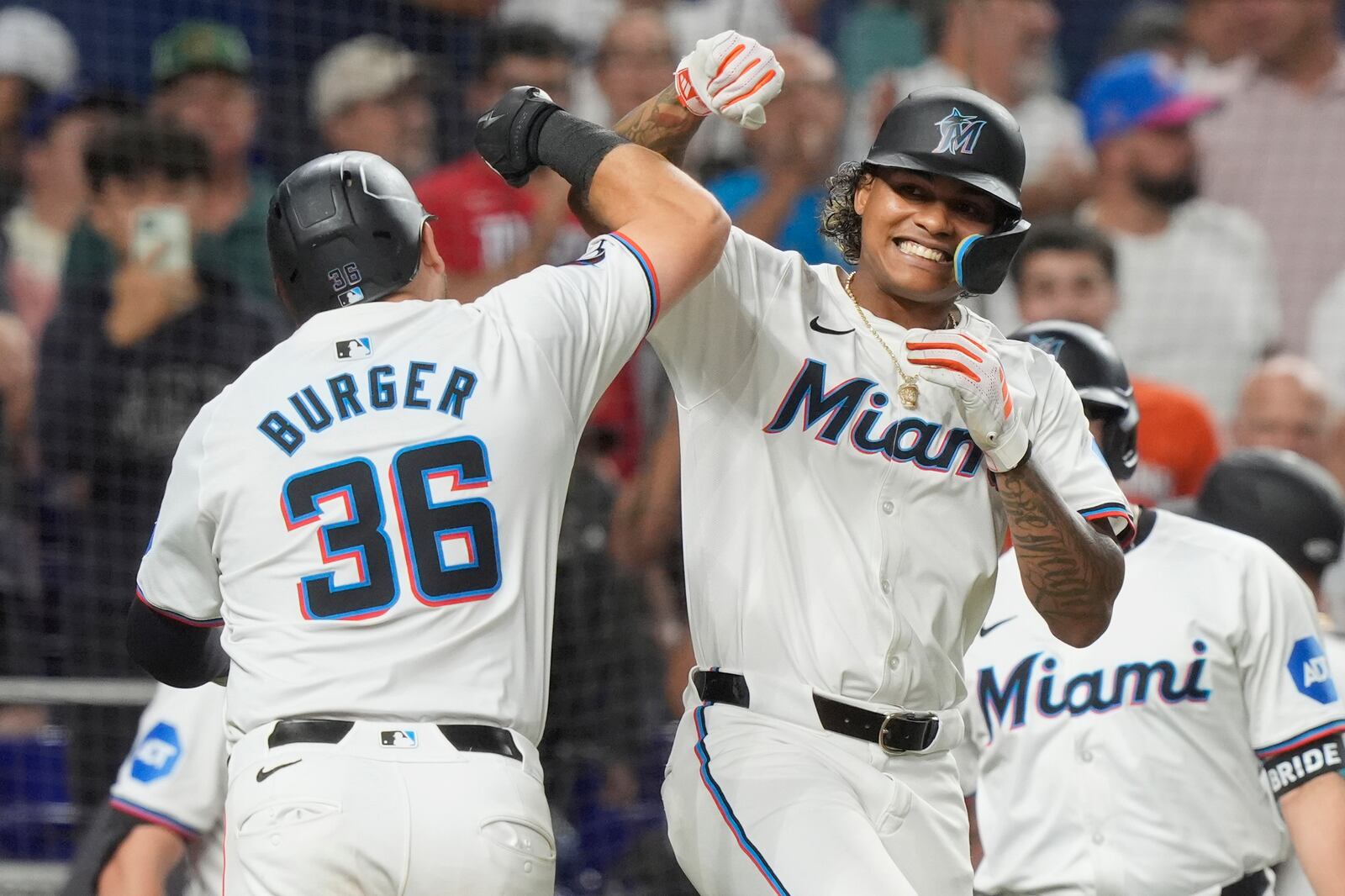 FILE - Miami Marlins' Cristian Pache and Jake Burger (36) celebrate Burger's two-run home run doing the eighth inning of a baseball game against the Los Angeles Dodgers, Tuesday, Sept. 17, 2024, in Miami. (AP Photo/Marta Lavandier, File)