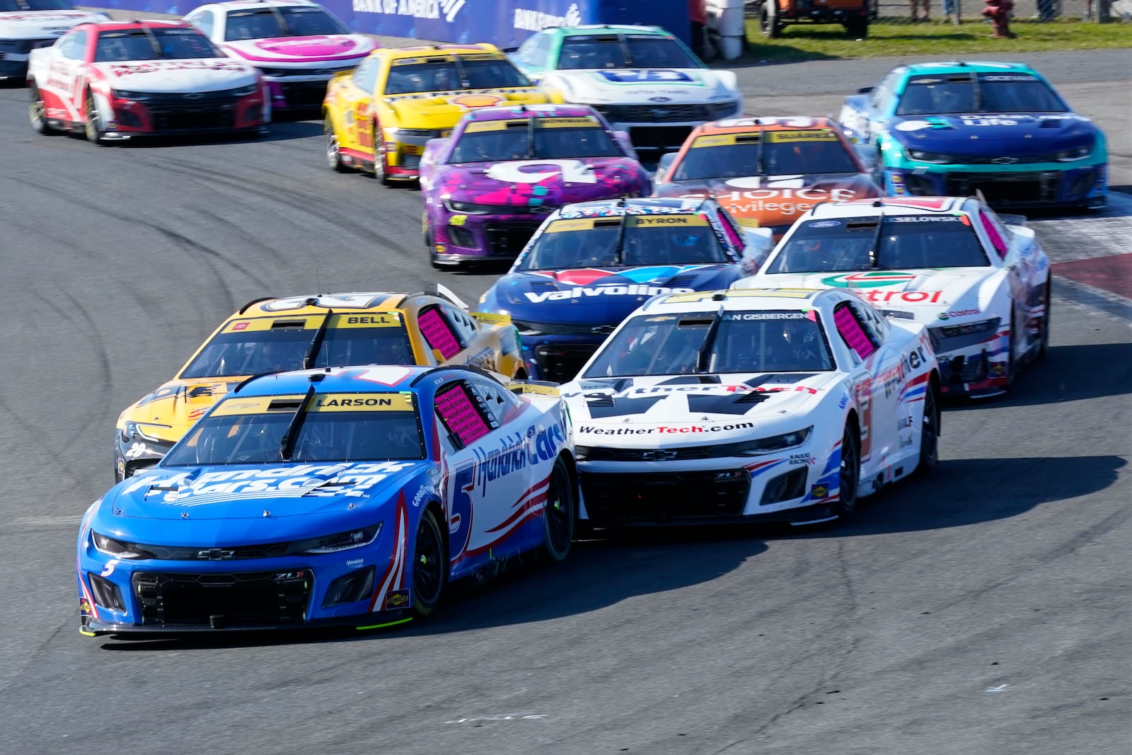 Kyle Larson (5) leads the field on a restart during a NASCAR Cup Series auto race at Charlotte Motor Speedway in Concord, N.C., Sunday, Oct. 13, 2024. (AP Photo/Chuck Burton)