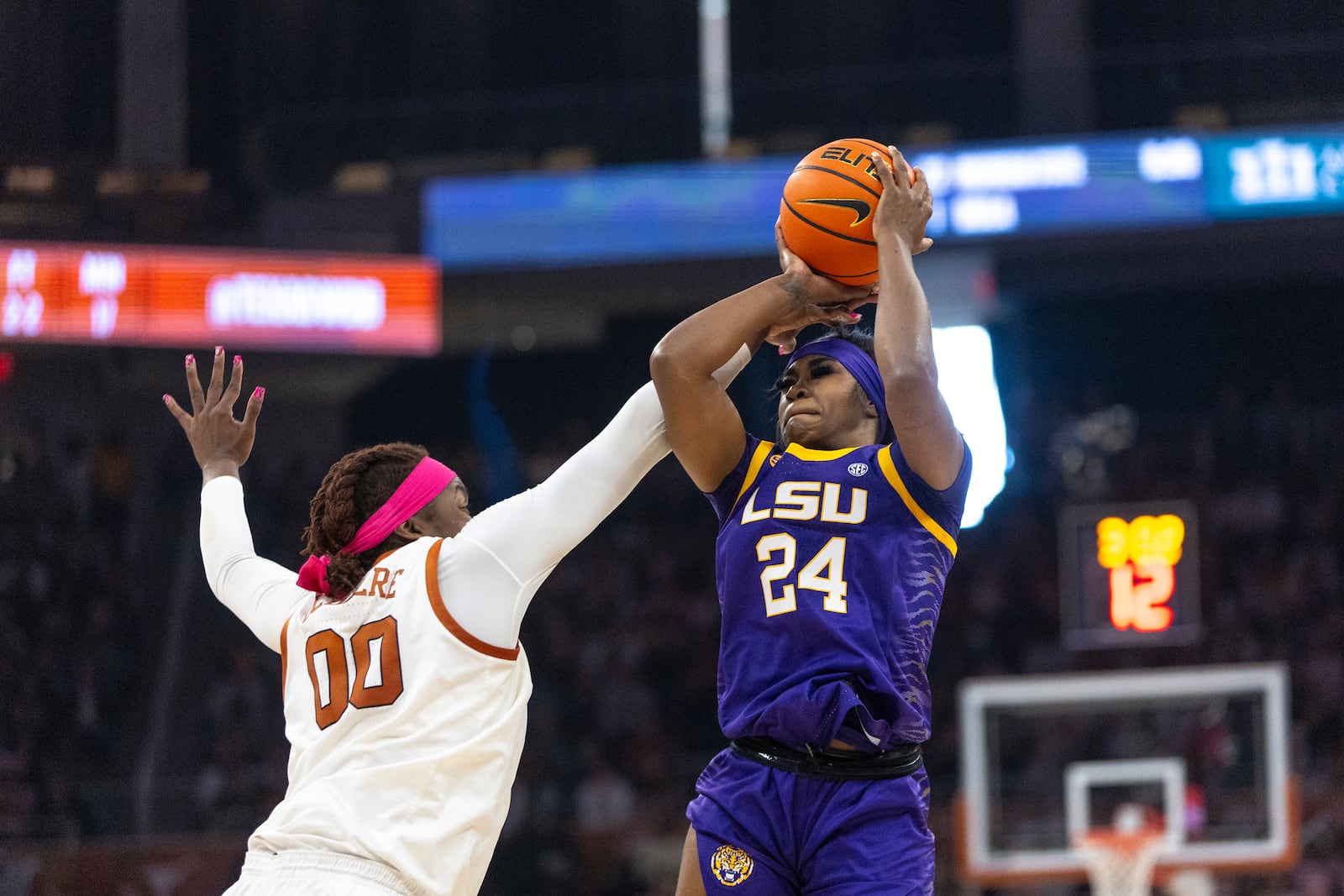 Texas forward Kyla Oldacre (00) defends LSU guard Aneesah Morrow (24) during the first half of an NCAA college basketball game in Austin, Texas, Sunday, Feb. 16, 2025. (AP Photo/Stephen Spillman)