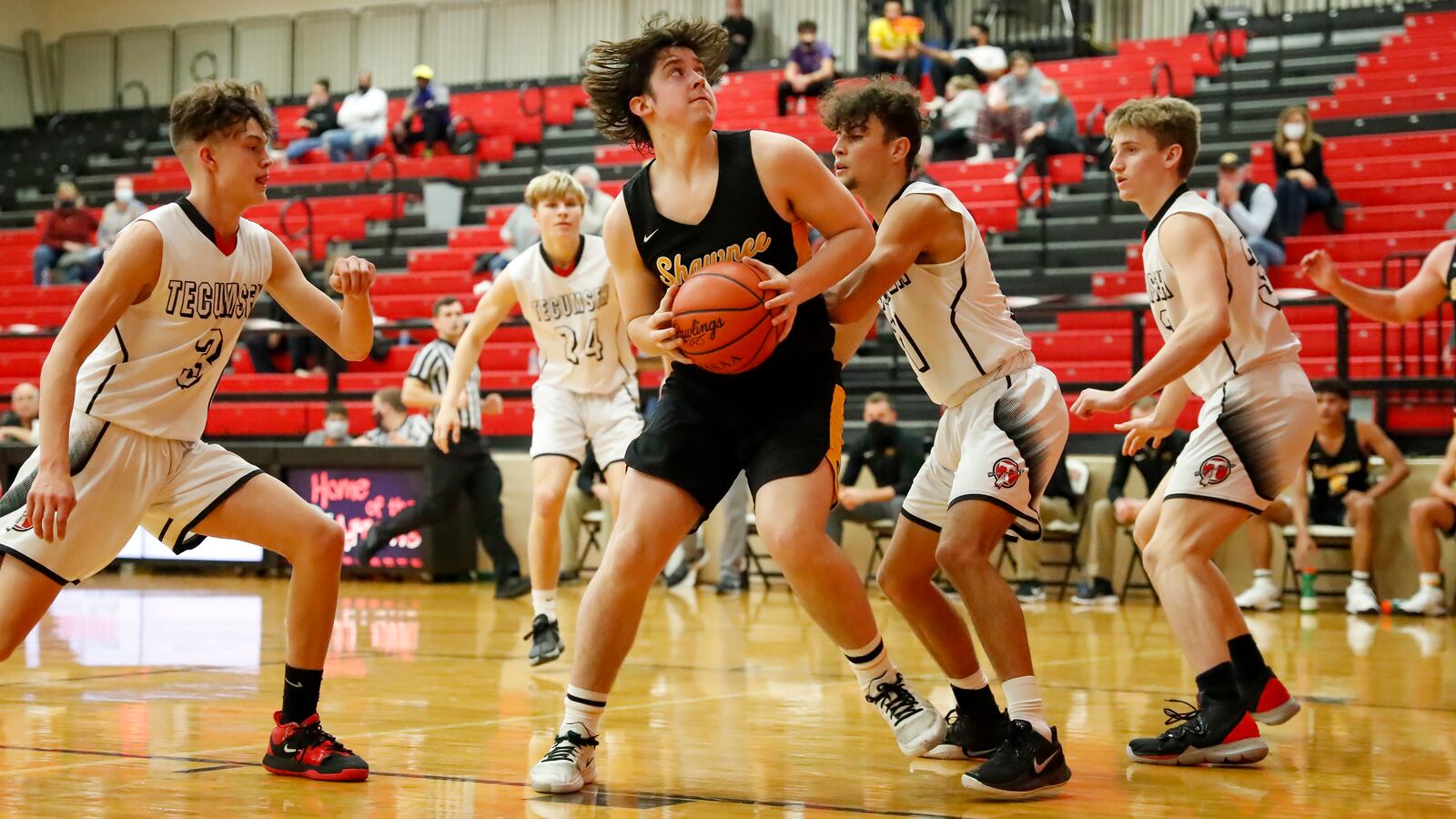 Braves2: Shawnee High School junior Mason Griffith spins to the hoop against Tecumseh's Brendan Toops (11) during their game on Friday night at Reynolds Gym in New Carlisle. The Braves won 69-53. Michael Cooper/CONTRIBUTED