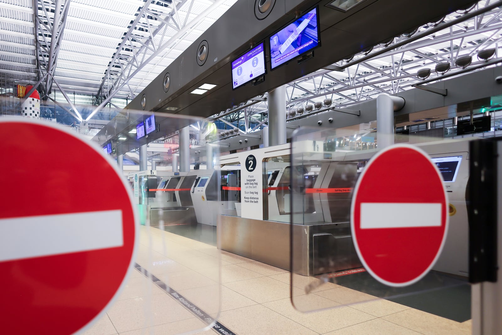 The signs ""Passage prohibited"" can be seen at a check-in counter in Terminal 1 at Hamburg Airport, Germany Monday, March 10, 2025. (Christian Charisius/dpa via AP)