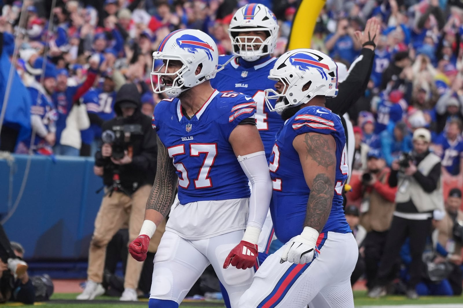 Buffalo Bills defensive end AJ Epenesa (57) celebrates after he sacked New York Jets quarterback Aaron Rodgers in the end zone for a safety during the first half of an NFL football game, Sunday, Dec. 29, 2024, in Orchard Park, N.Y. (AP Photo/Gene J. Puskar)