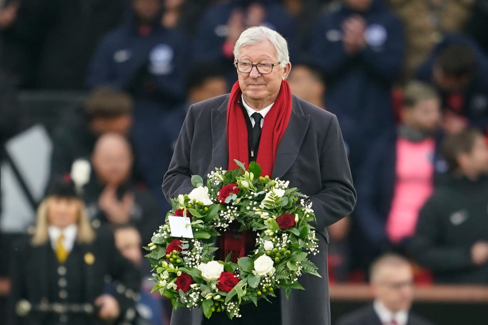 Manchester United former manager Sir Alex Fergusson arrives to lay a floral tribute for Denis Law prior to the start of the English Premier League soccer match between Manchester United and Brighton and Hove Albion, at the Old Trafford stadium in Manchester, England, Sunday, Jan. 19, 2025. (AP Photo/Dave Thompson)