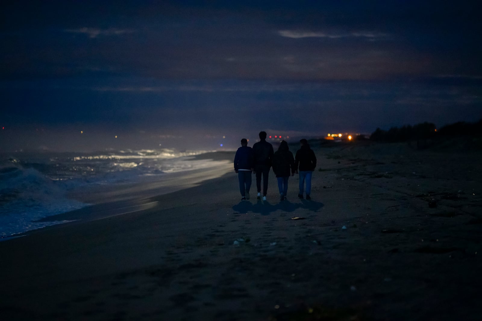 FILE - Survivors and relatives of victims walk, Feb. 26, 2024, at the site where a migrant boat capsized a year earlier in Steccato di Cutro, on the Italian southern tip. AP Photo/Valeria Ferraro, File)