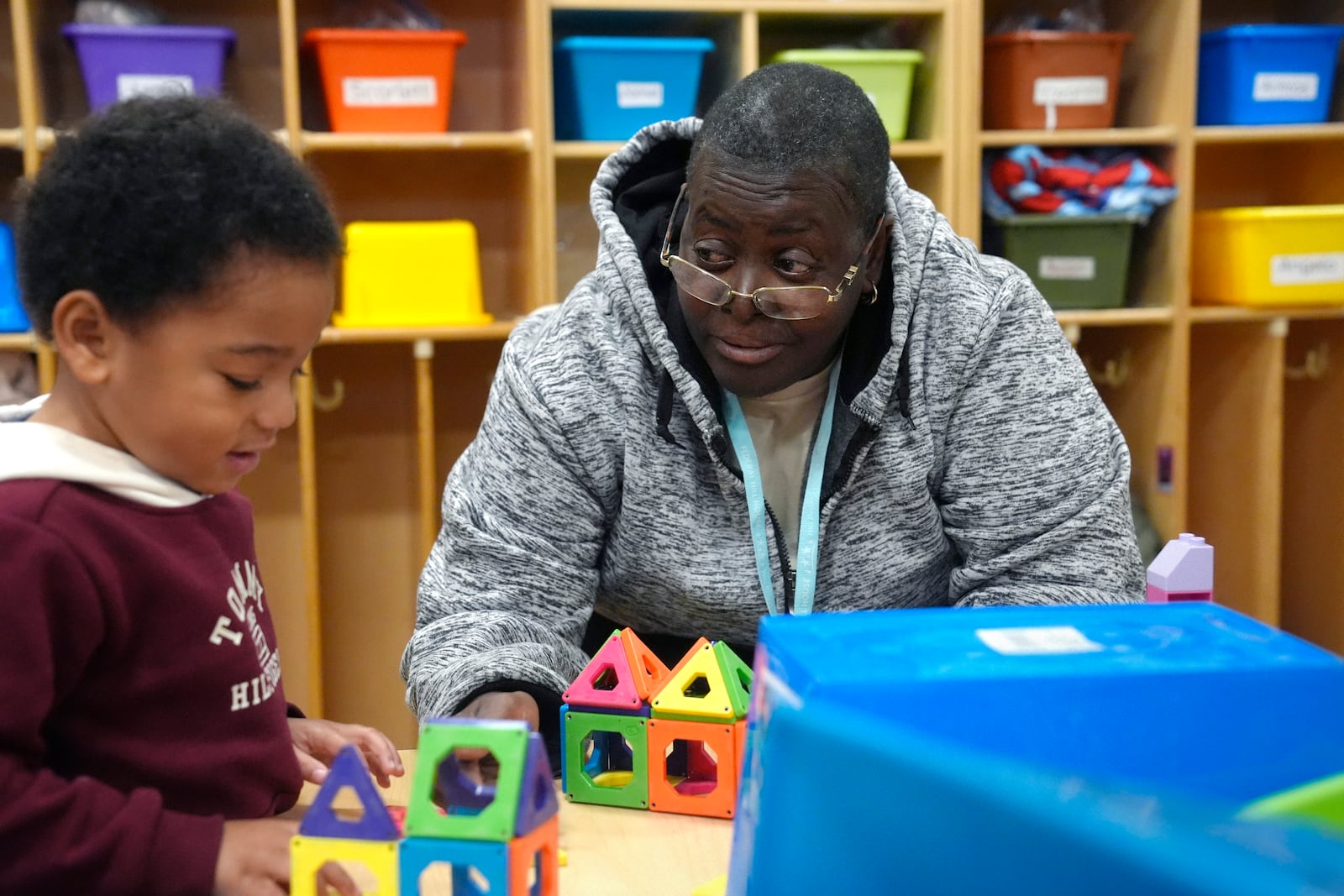 Volunteer Mirna Cruz Mangual, 59, of Providence, R.I., right, supervises three-year-old Yovanni Freeman, left, in an early childcare program at Federal Hill House, Tuesday, Nov. 12, 2024, in Providence, R.I. (AP Photo/Steven Senne)