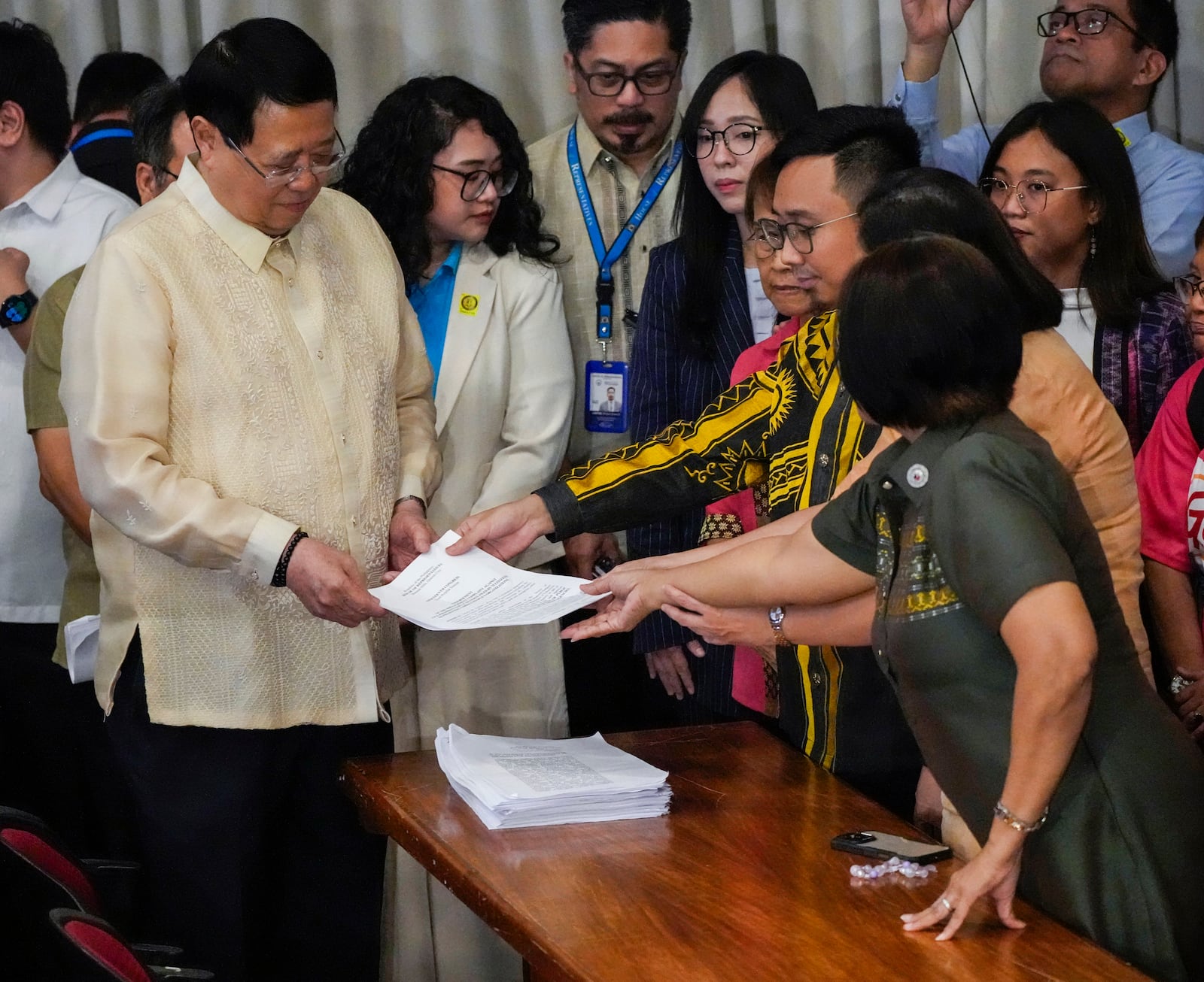 House Secretary General, Reginald Velasco, left, receives a second impeachment complaint filed against Philippine Vice President Sara Duterte by a group led by left-wing activists on Wednesday Dec. 4, 2024 at the House of Representatives in Quezon City, Philippines. (AP Photo/Aaron Favila)