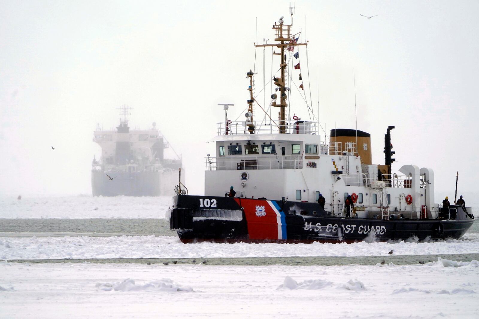 The U.S. Coast Guard Cutter Bristol Bay heads into Buffalo Harbor after spending the day breaking ice, Friday, Jan. 24, 2025, on Lake Erie around the lake freighter Manitoulin, which has been immobilized by thick lake ice since departing Buffalo on Wednesday morning, Jan. 22. (Derek Gee/The Buffalo News via AP)