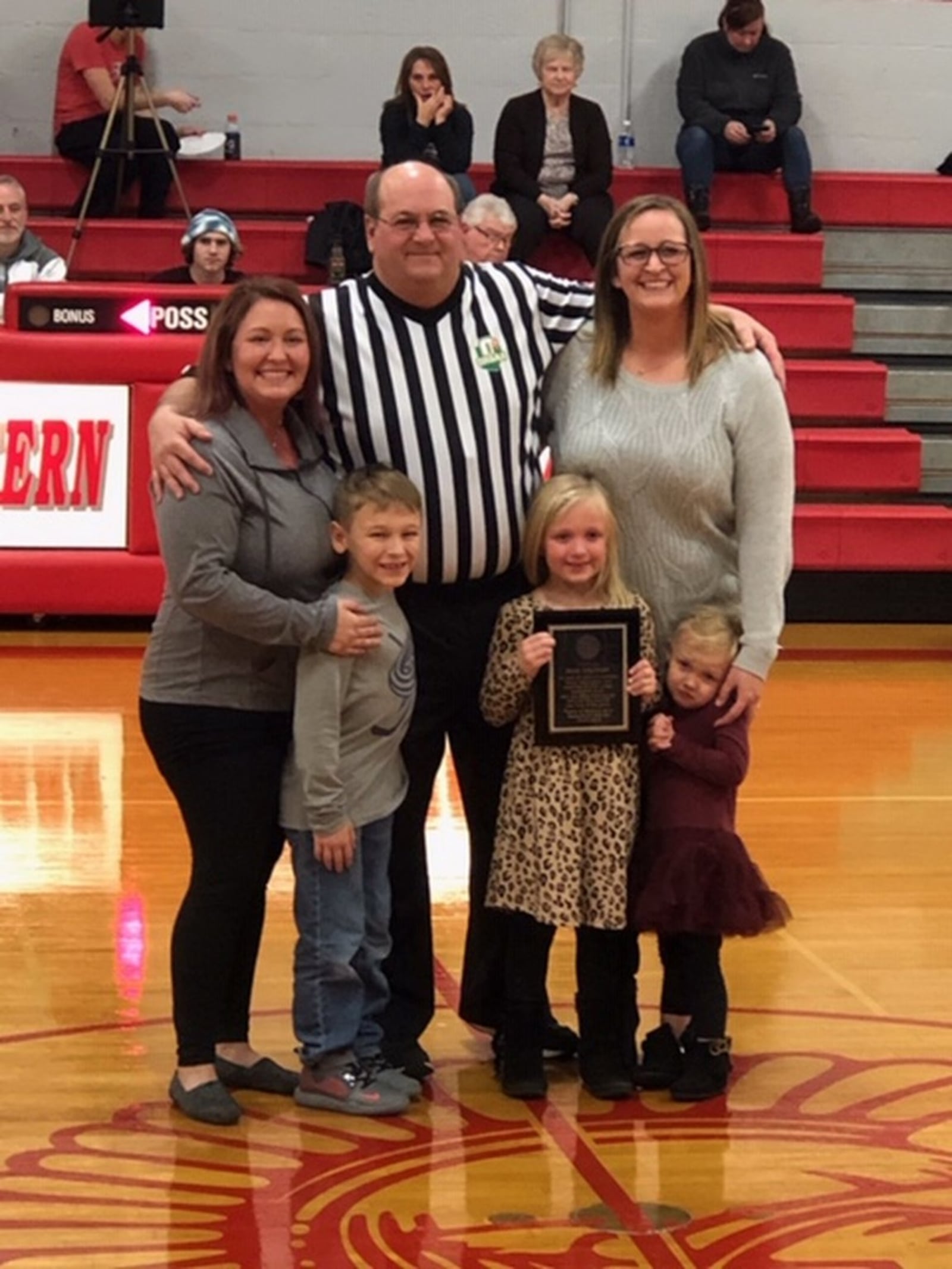 Rick Delaney (center) recently officiated the final high school basketball game of his 40-year career. Delaney is pictured with his daughters and grandkids. From left: Amanda Holt, Jackson Holt, Rick Delaney, Delaney Hiser, Jessica Hiser and Parker Hiser. CONTRIBUTED