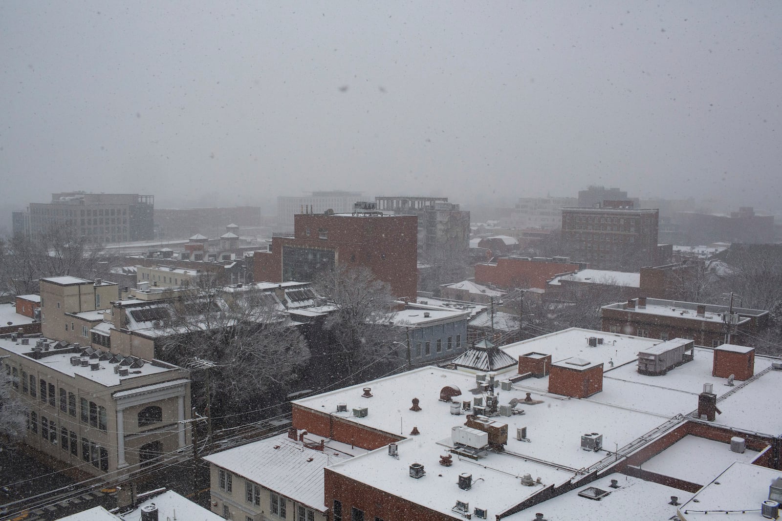 Snow covers rooftops as a winter snowstorm hits Charlottesville, Va., Tuesday, Feb. 11, 2025. (Cal Cary/The Daily Progress via AP)