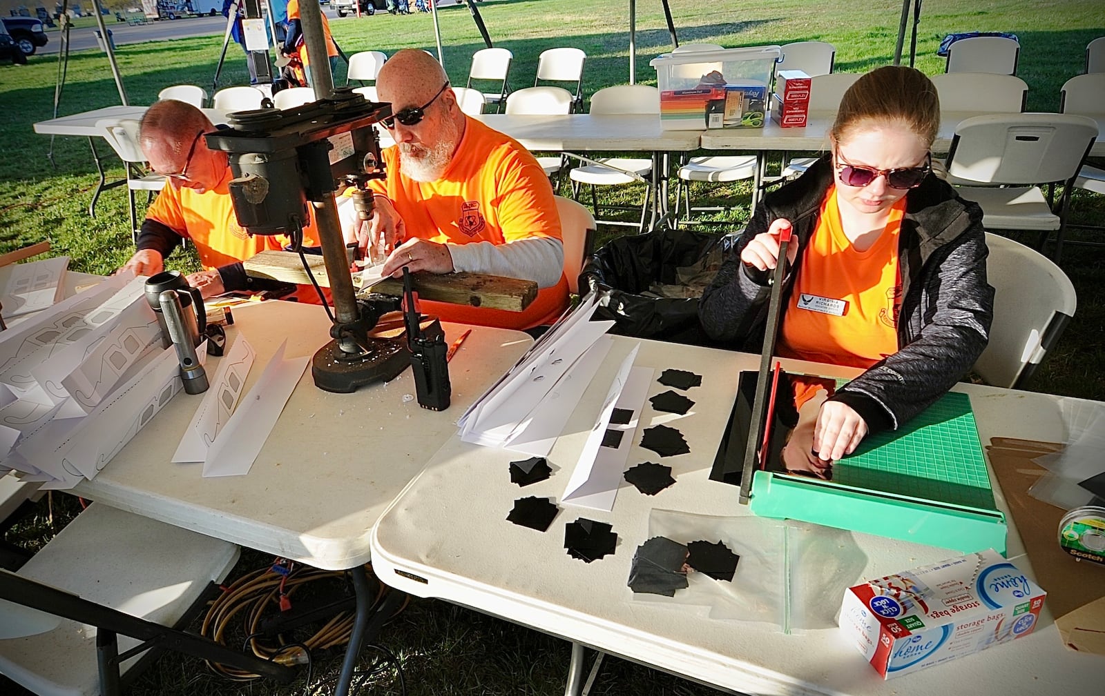 The education department of the Air Force Museum from left, Mike Brimmer, Pat Hannon and Virginia Richards make the parts and pieces for eclipse glasses for children to make at the museum Monday, April 8, 2024. The museum offers lots of activities for free for families. MARSHALL GORBY \STAFF