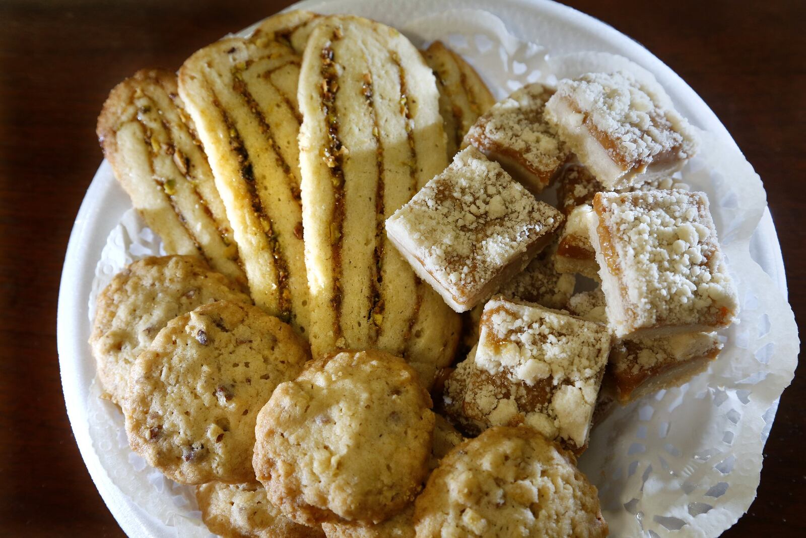 The winners of the 2017 Dayton Daily News Cookie Contest are: First place (center) Peachy Pistachio Icebox Cookies by Roxanne Williams of Springboro, second place (left) Potato Chip Cookies by Carol Foltz of Miami Twp. and third place (right) Salted Caramel Butter Bars by Geni Thurin of Dayton. LISA POWELL / STAFF