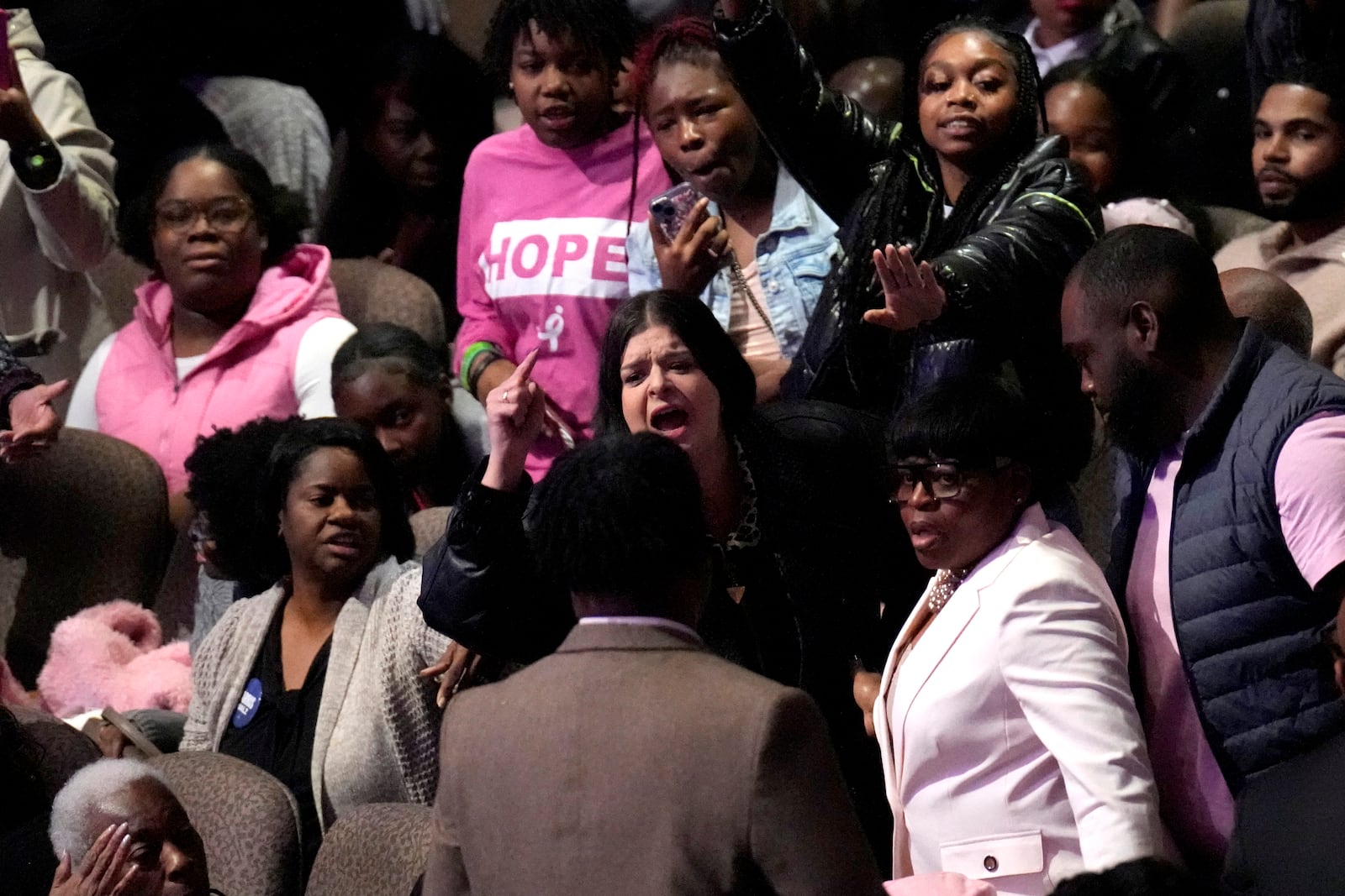 A protester, center, demonstrates as Democratic presidential nominee Vice President Kamala Harris speaks at a church service at New Birth Baptist Church in Stonecrest, Ga., Sunday, Oct. 20, 2024. (AP Photo/Jacquelyn Martin)