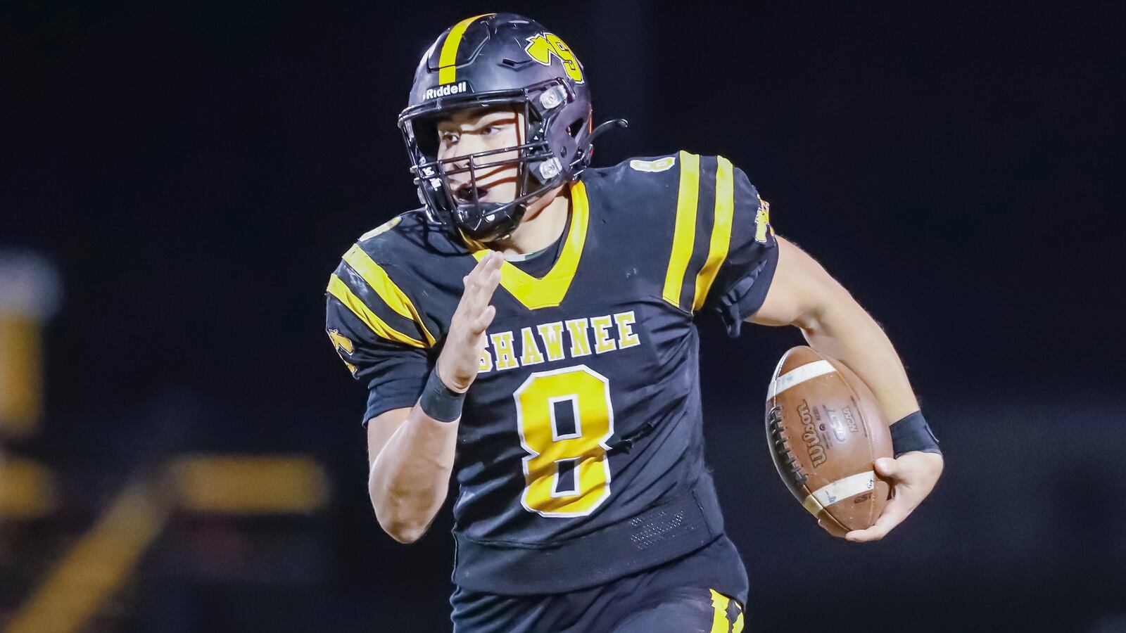 Shawnee High School senior running back Max Guyer carries the ball during their game against Roger Bacon on Friday night in Springfield. The Braves won 33-7. CONTRIBUTED PHOTO BY MICHAEL COOPER