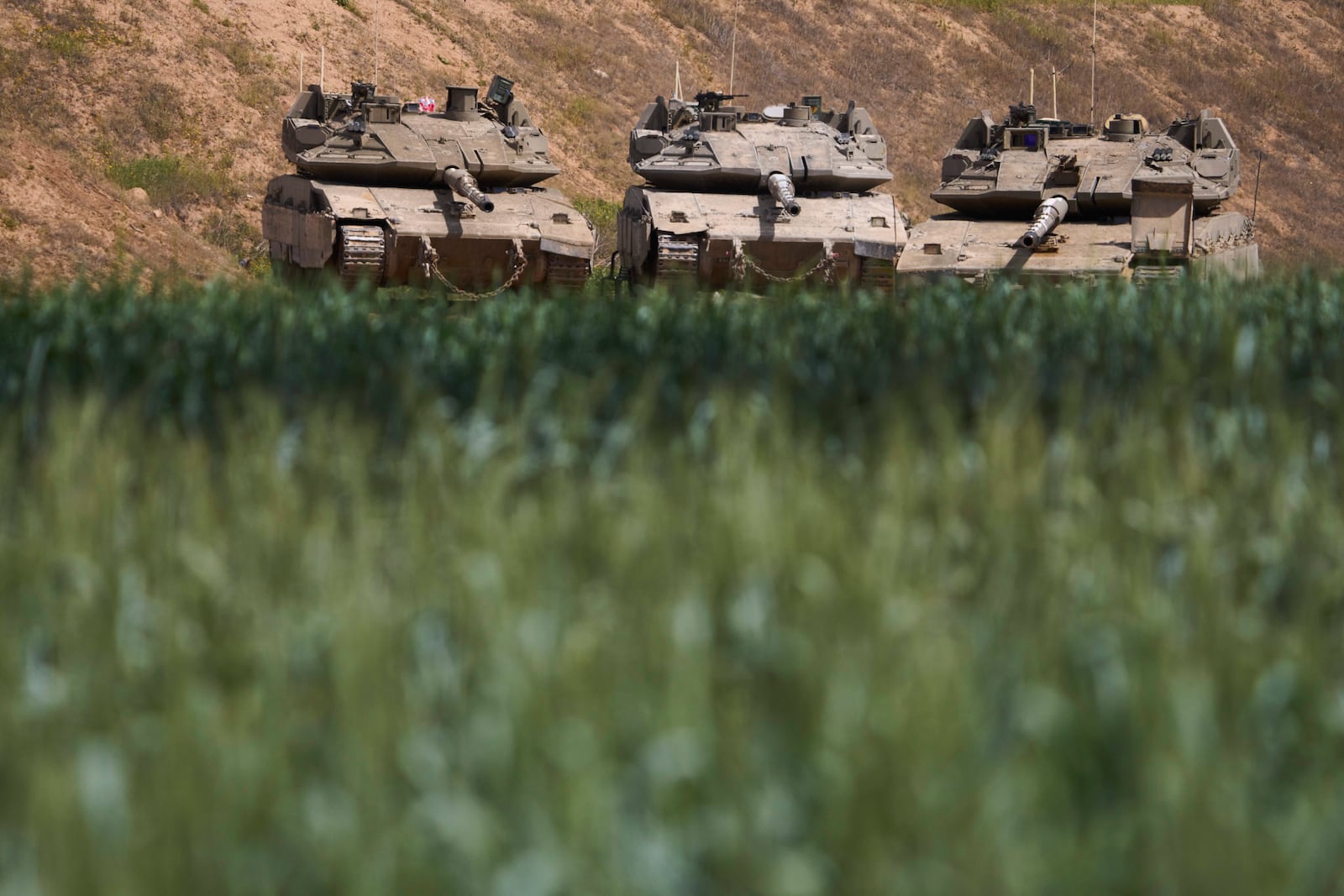 Israeli tanks at a position near the Gaza border in southern Israel, Wednesday, March 19, 2025. (AP Photo/Ariel Schalit)