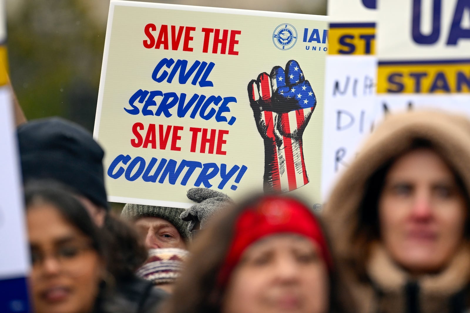 People rally at Health and Human Services headquarters to protest the polices of President Donald Trump and Elon Musk Wednesday, Feb. 19, 2025, in Washington. (AP Photo/John McDonnell)