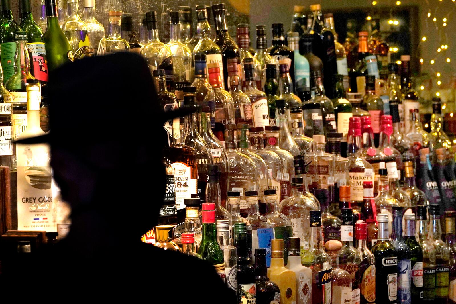 FILE - Bottles of alcohol sit on shelves at a bar in Houston, June 23, 2020. (AP Photo/David J. Phillip, File)