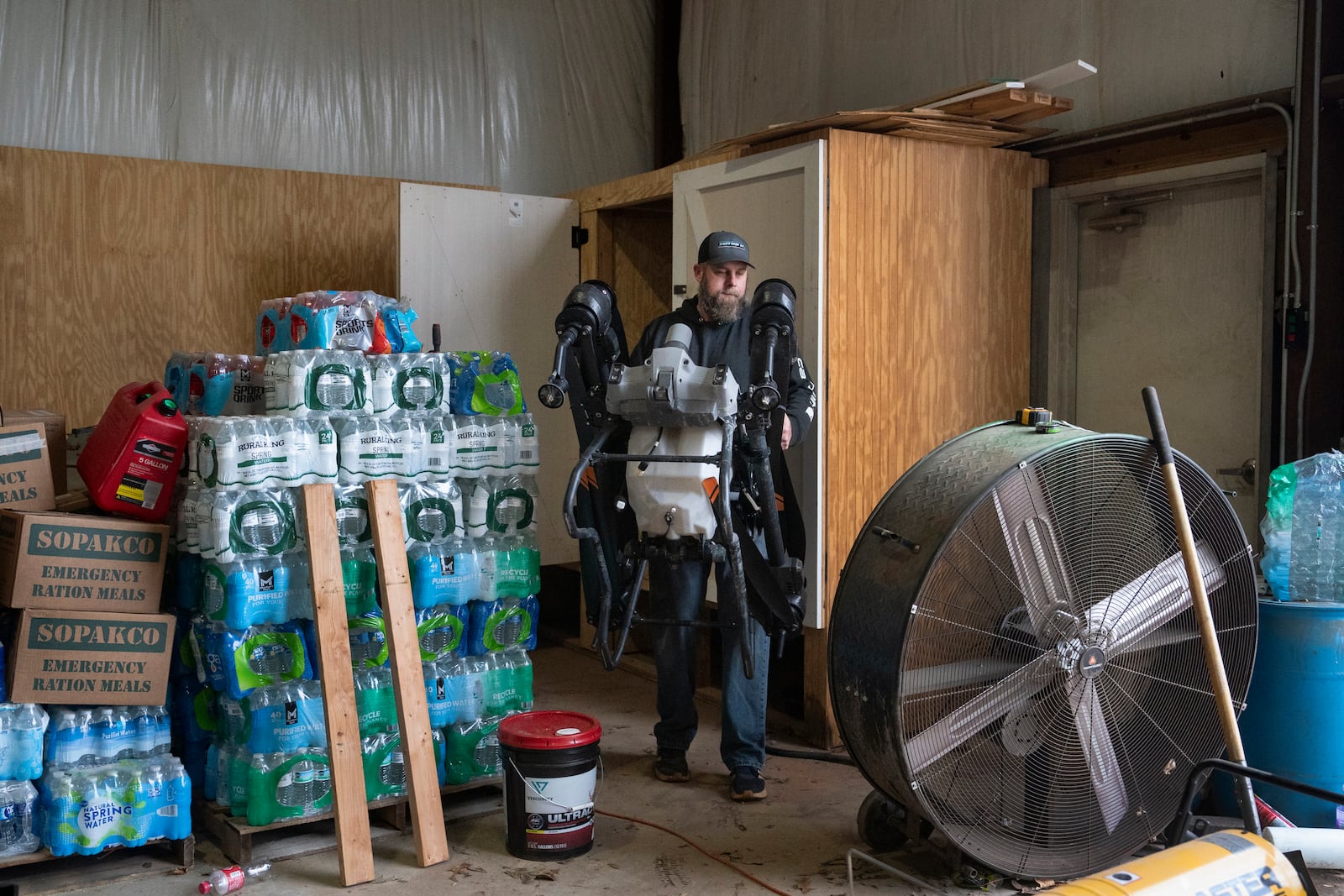 Russell Hedrick takes a DJI drone out of the closet to put crop cover on his farm, Tuesday, Dec. 17, 2024, in Hickory, N.C. (AP Photo/Allison Joyce)