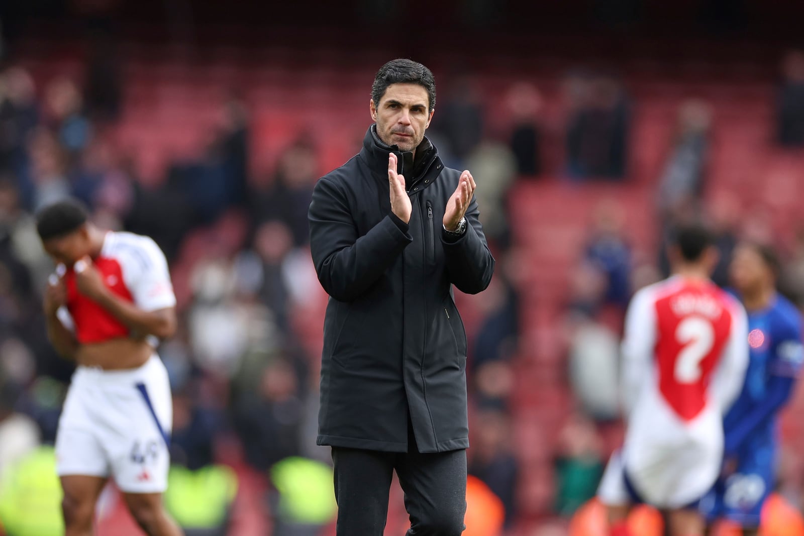 Arsenal's manager Mikel Arteta applauds supporters at the end of the English Premier League soccer match between Arsenal and Chelsea at Emirates stadium in London, Sunday, March 16, 2025. (AP Photo/Ian Walton)